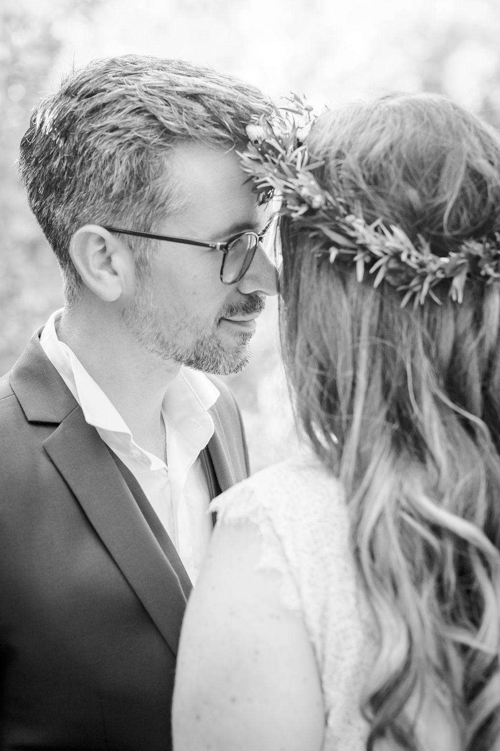 Black and white intimate wedding portrait sequence with floral crown detail.