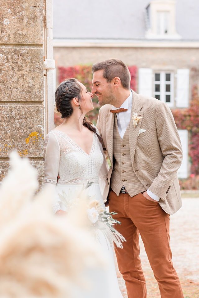 Intimate wedding moments captured against classic stone architecture and fall foliage.