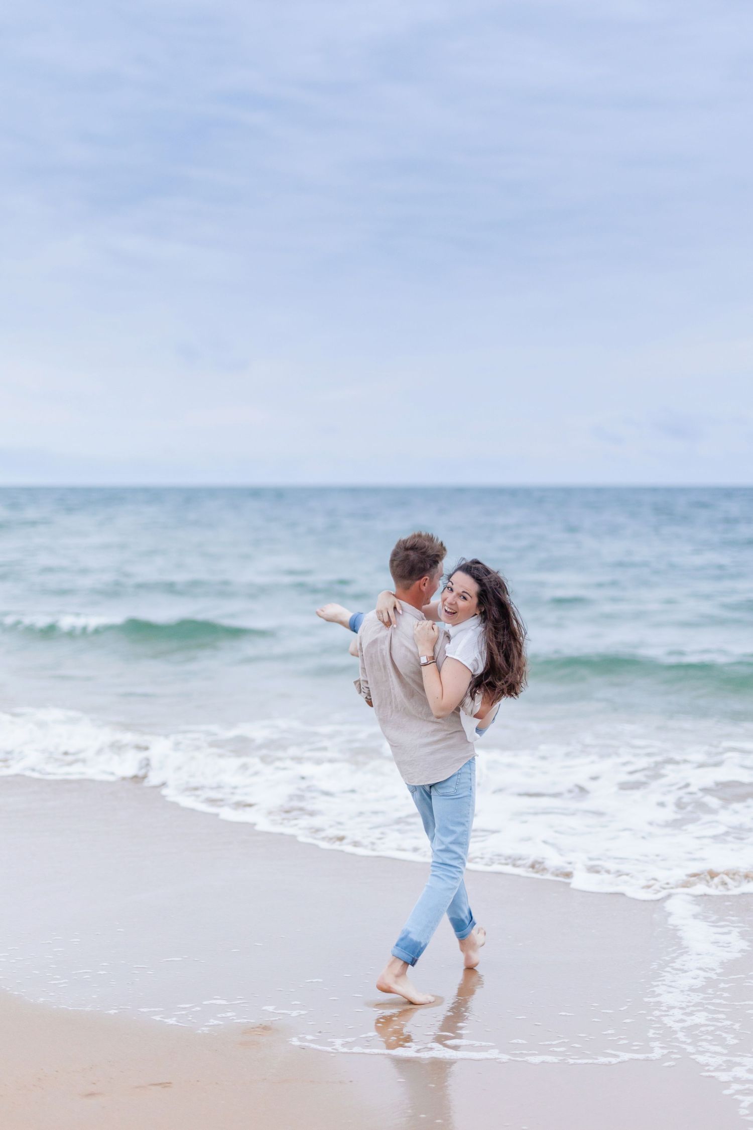A romantic lift on the beach with waves crashing in the background.
