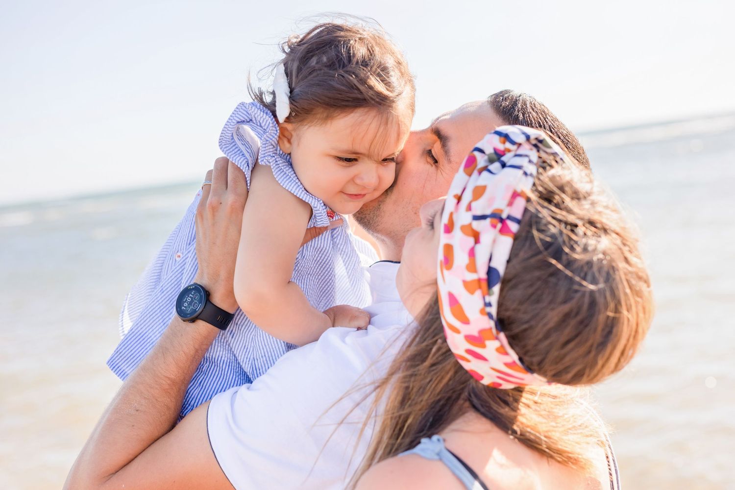 Sweet candid moment between family members at the beach.