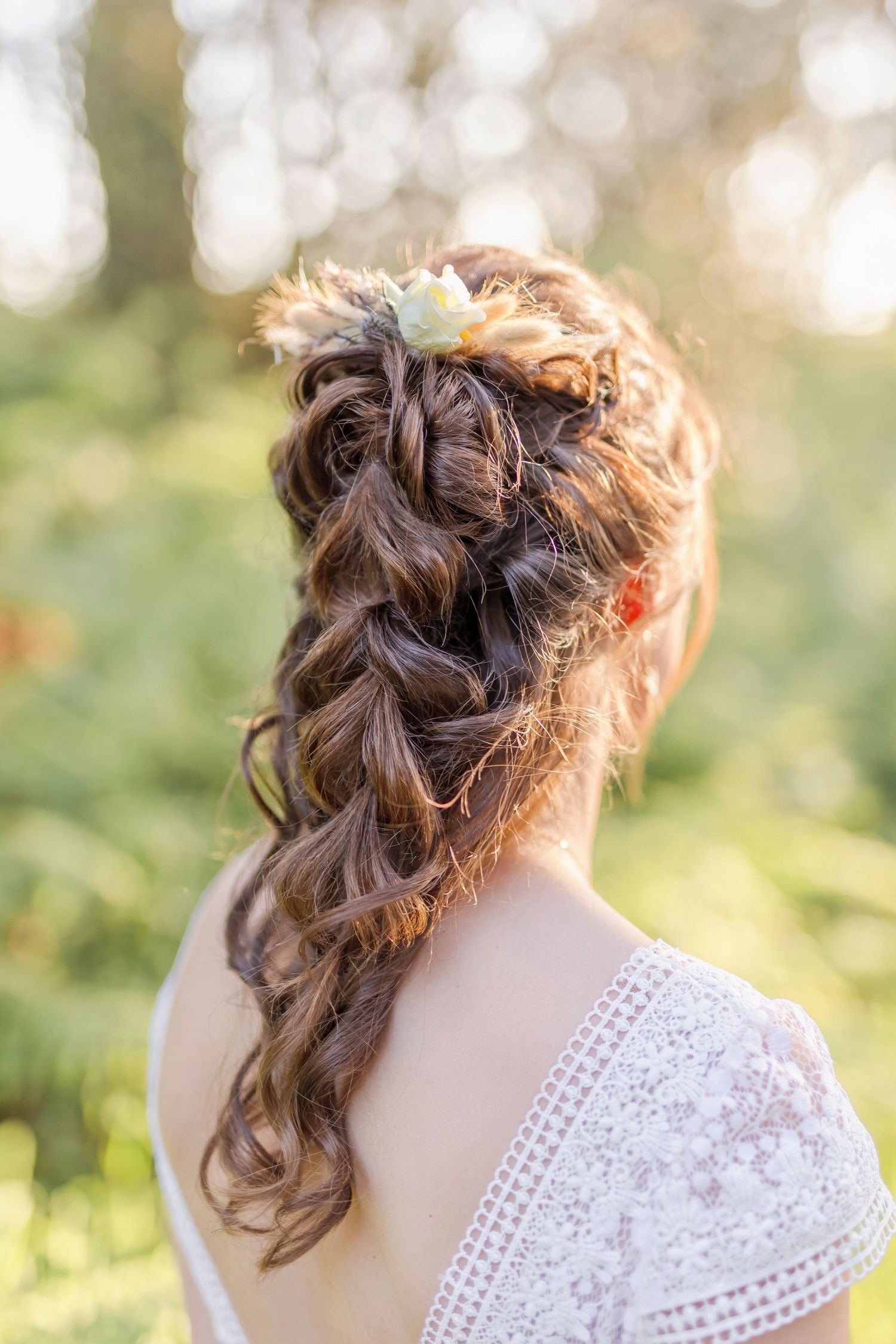 Close-up of an elegant bridal hairstyle with soft curls in natural lighting.