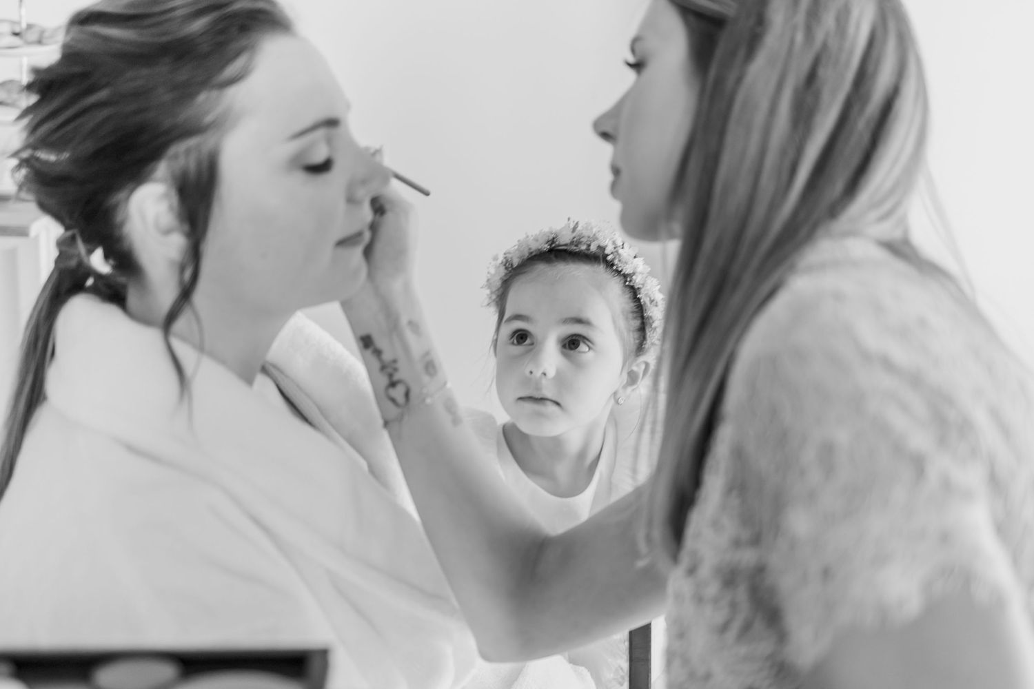 Makeup application in progress during a getting-ready session with a mirror reflection.