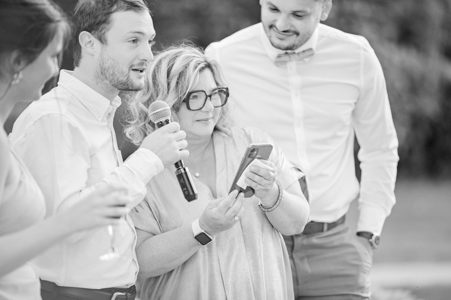 Wedding party laughing and celebrating together in black and white photo.