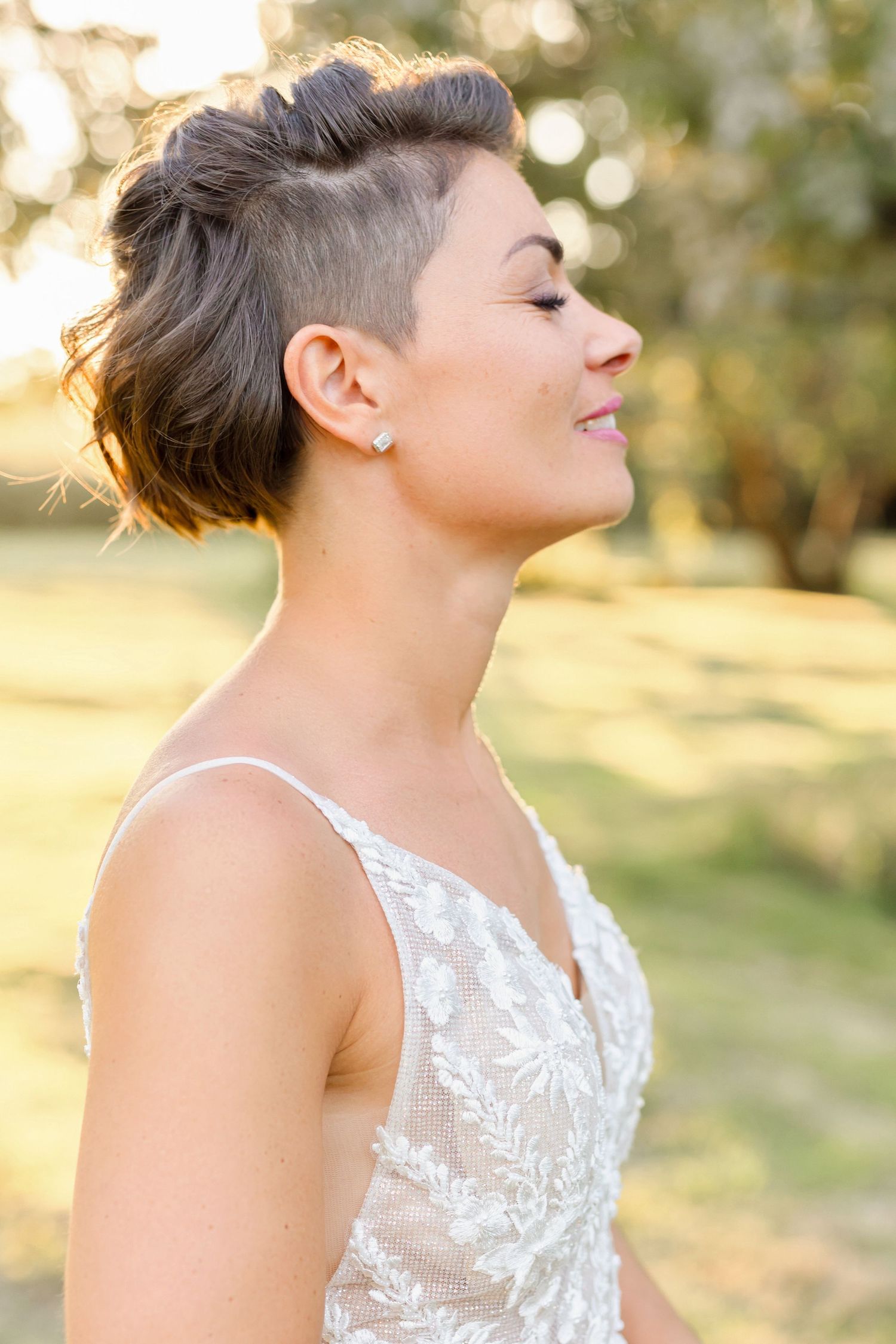 Side profile of a modern short hairstyle with shaved sides and textured top.