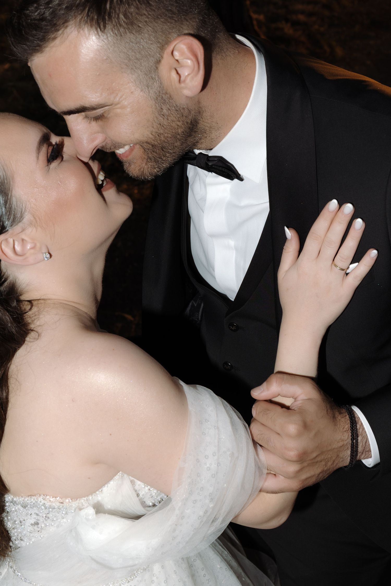 Romantic wedding couple sharing intimate moments in black and white photography series.