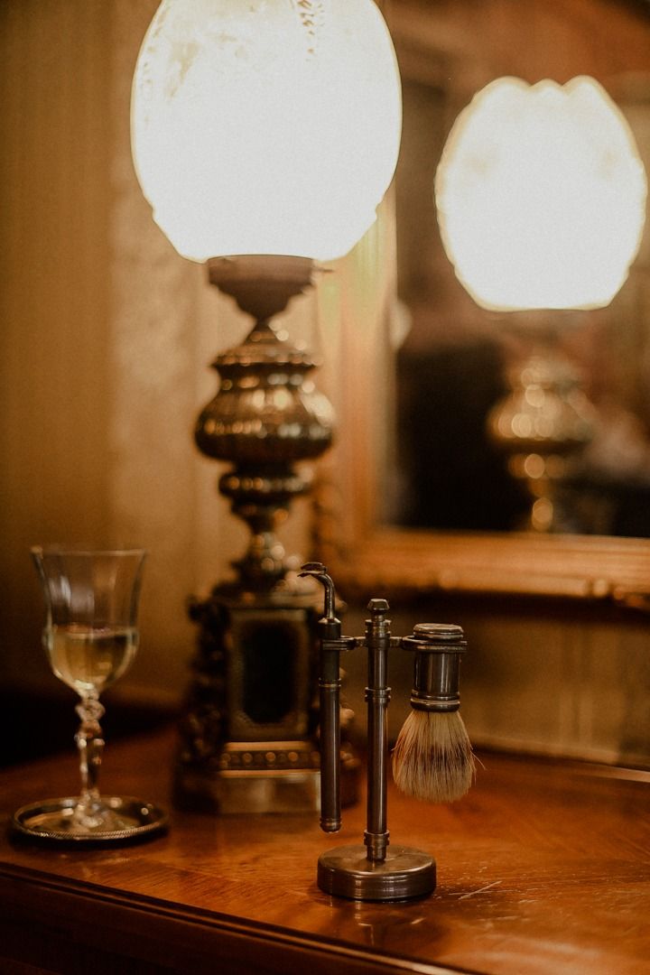 Vintage-style table setting with antique glass lamps creating warm ambient lighting.