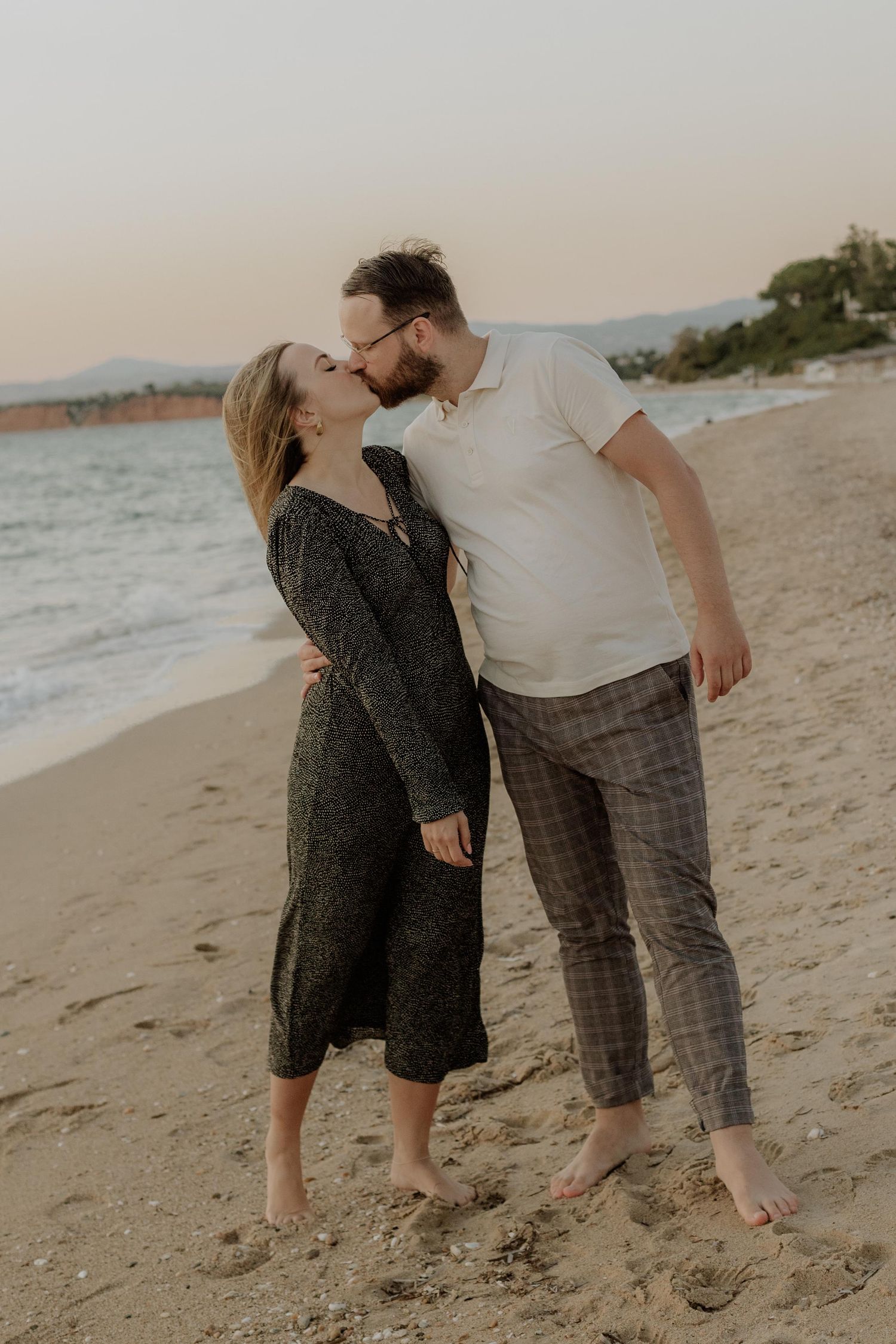 Candid moments of couple laughing and embracing on beach at golden hour.