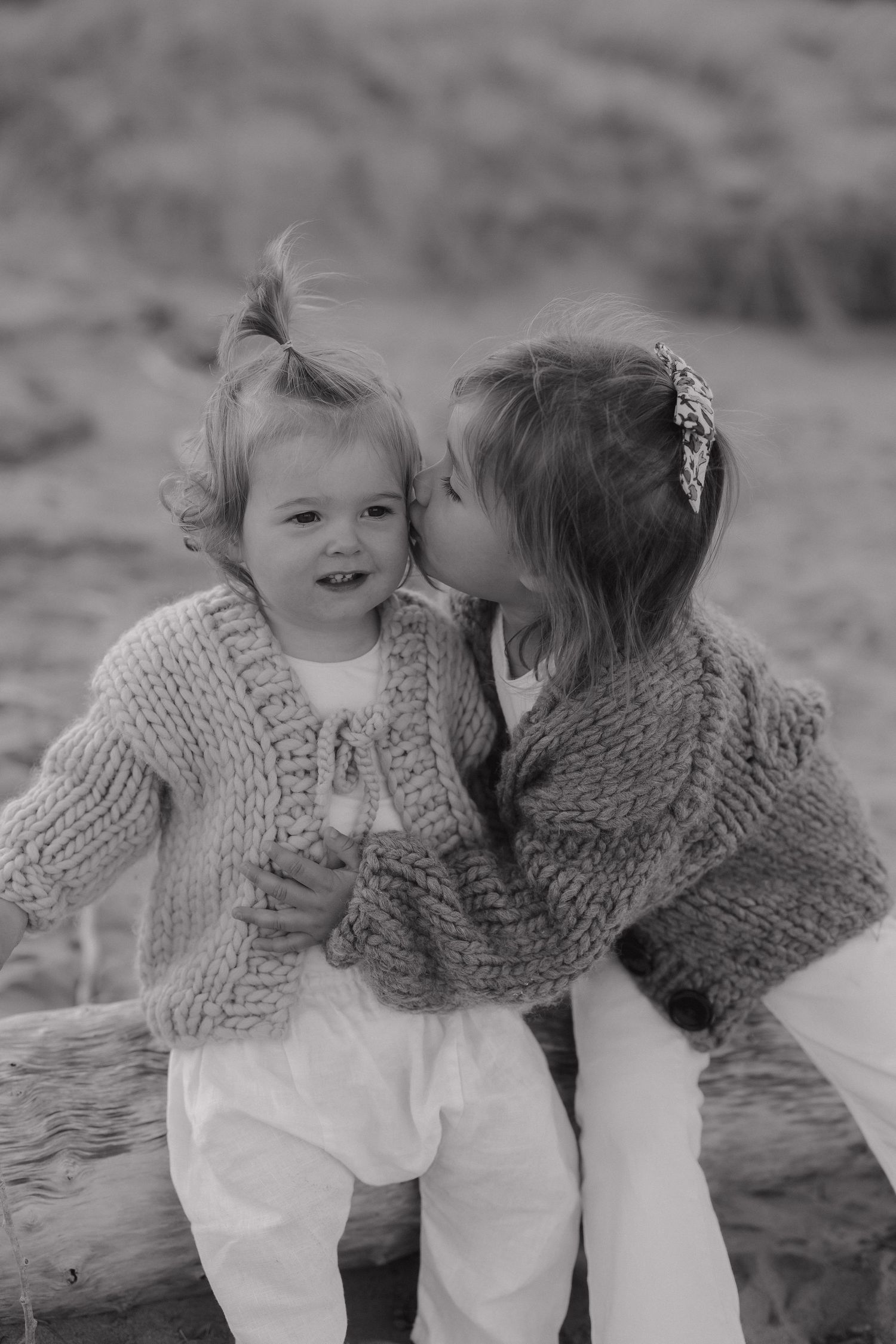 Black and white portrait capturing sweet interaction between family members.