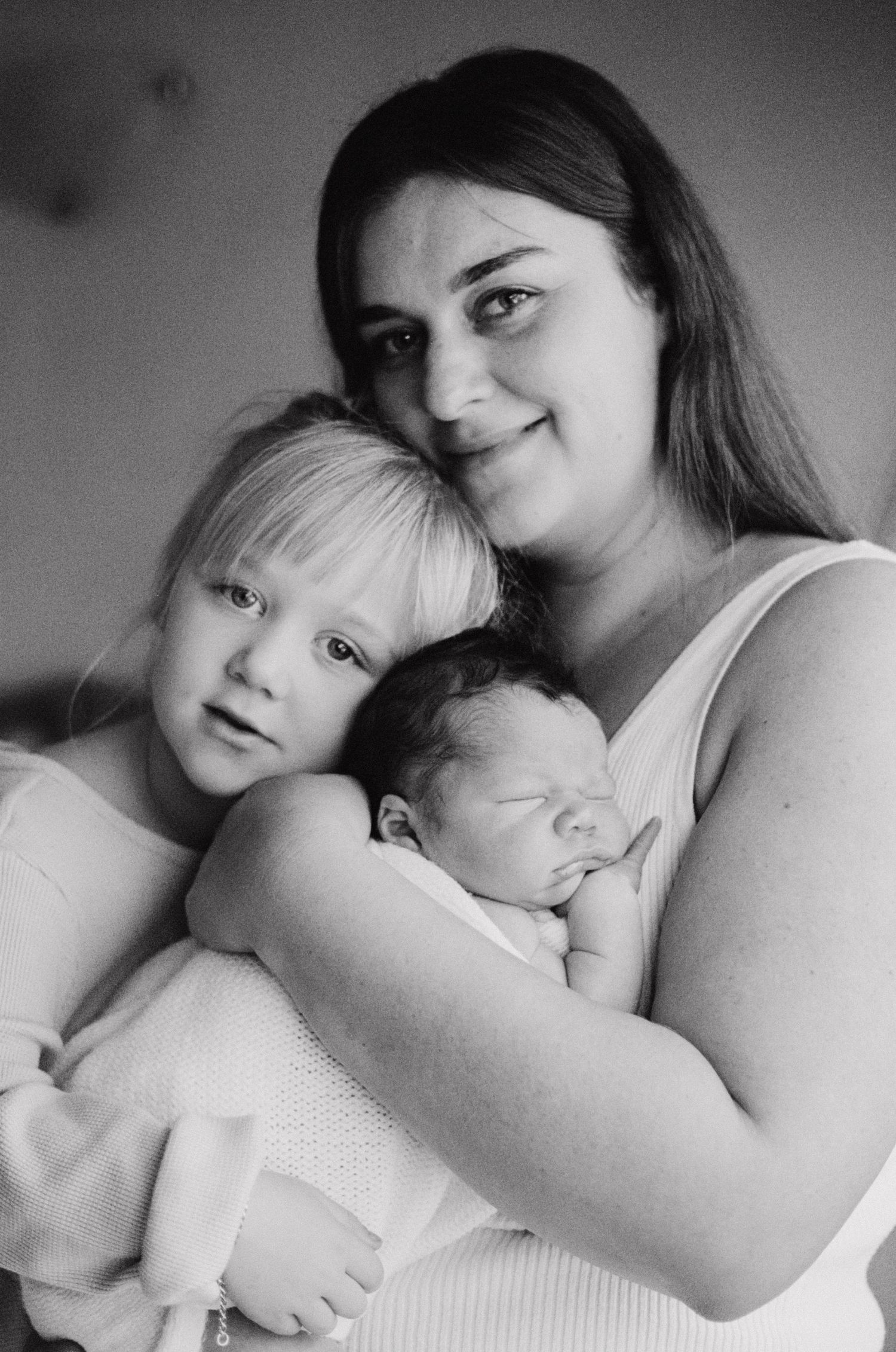 Heartwarming black and white family portrait with newborn.