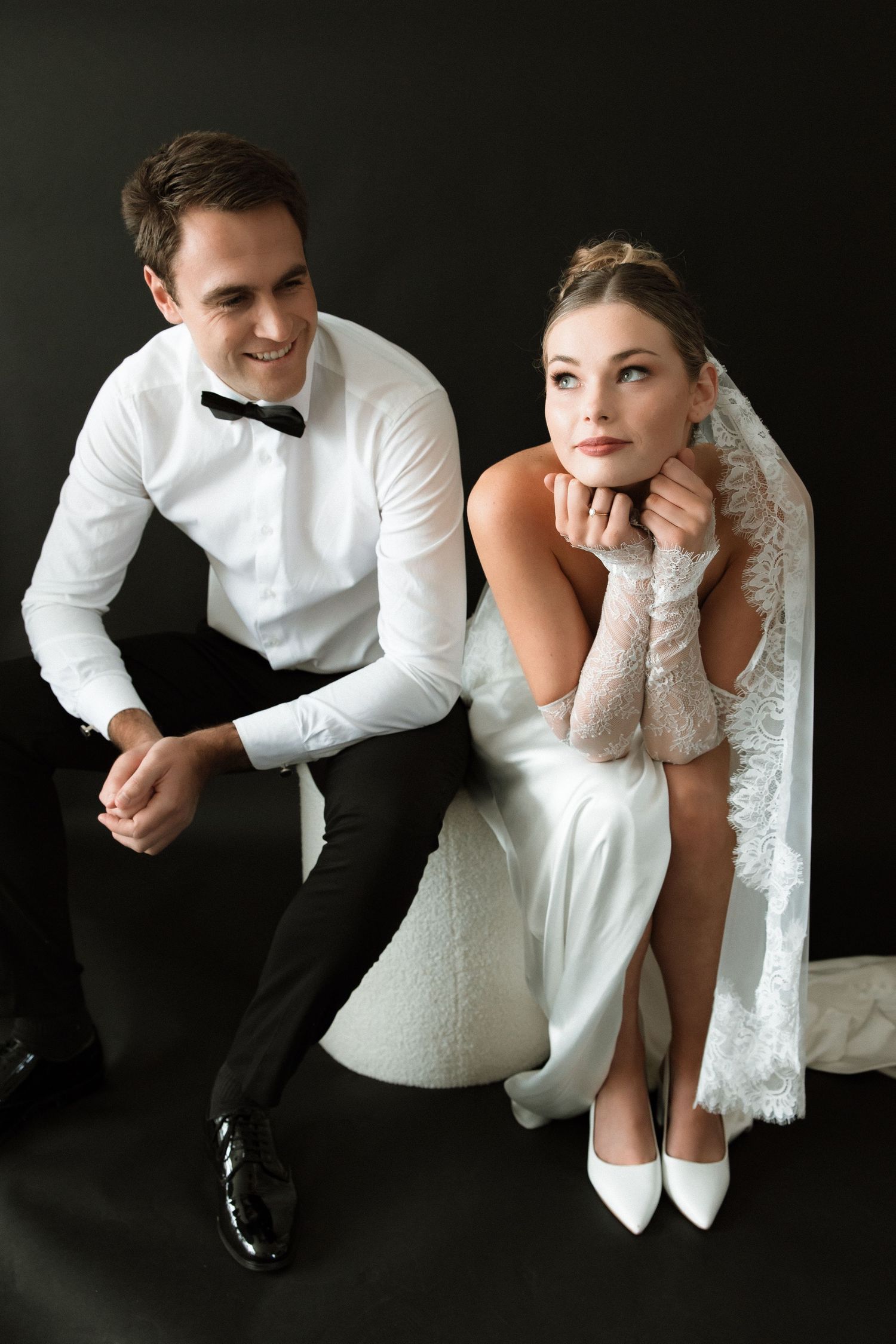 Contemporary black and white wedding portraits capture casual moments between couple.