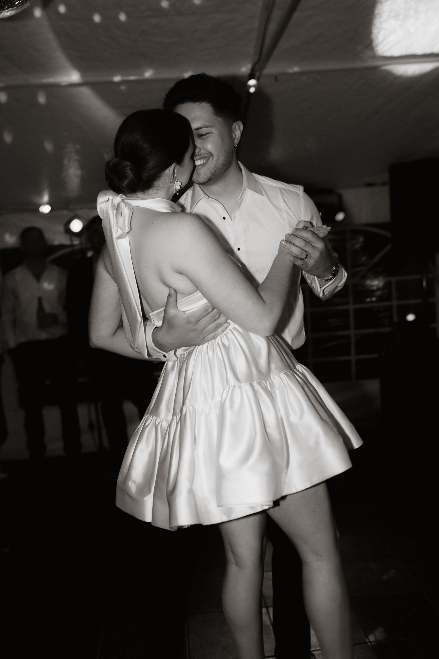 Black and white photos capture intimate dance moments at a wedding reception.
