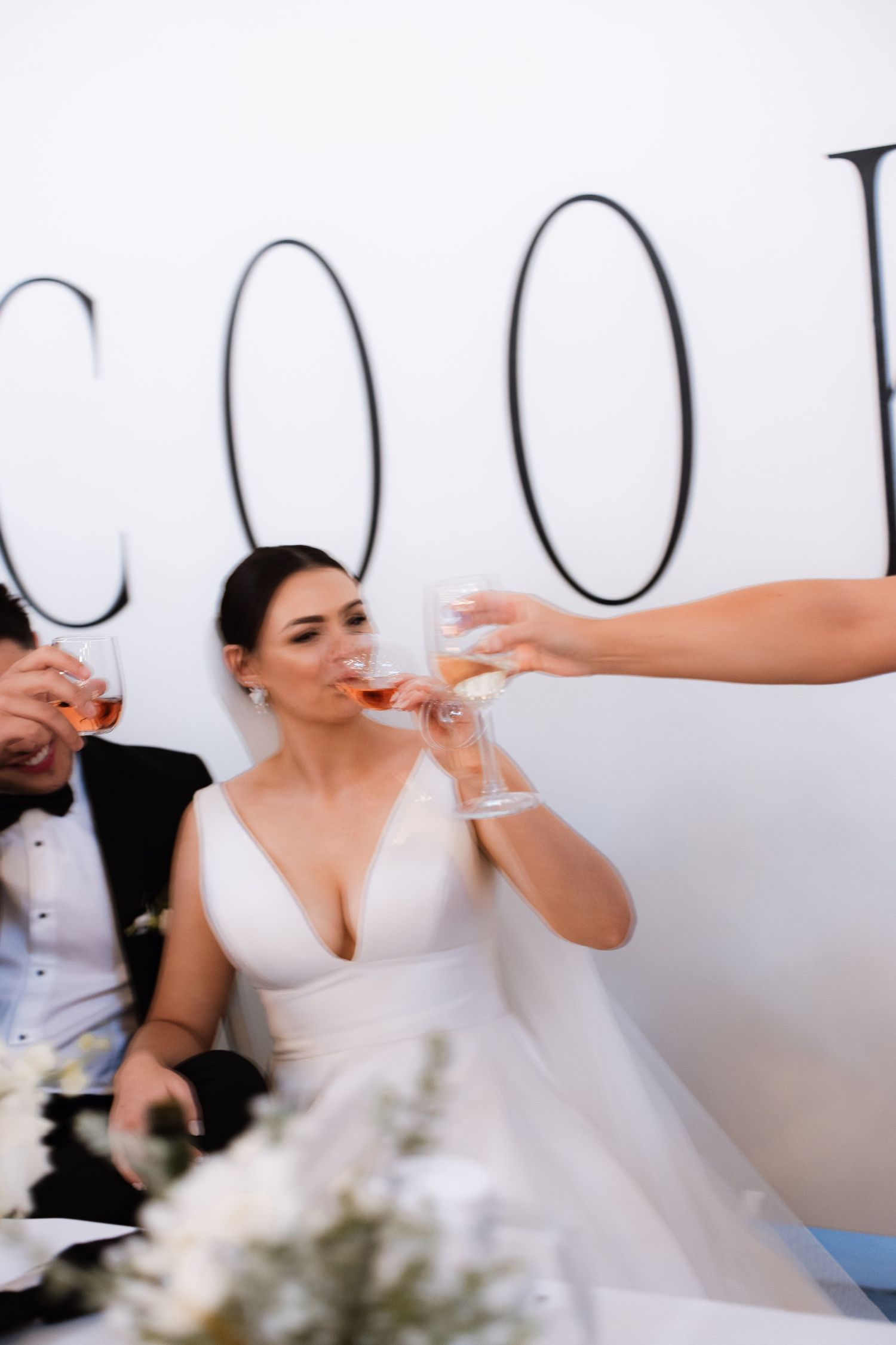 Close-up shots of a bride getting ready in a white dress against a light background.