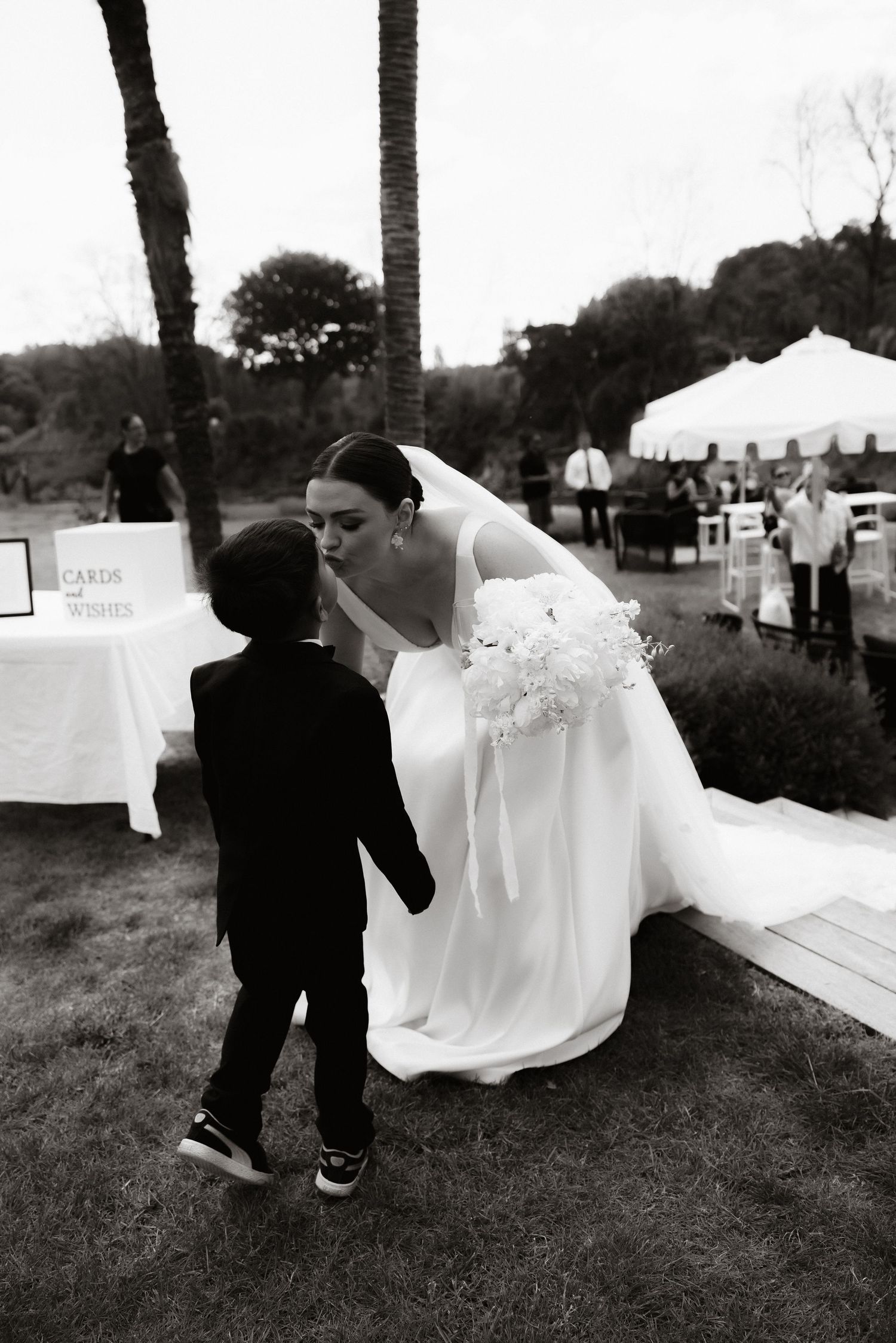 Black and white wedding photos taken outdoors with dramatic poses.