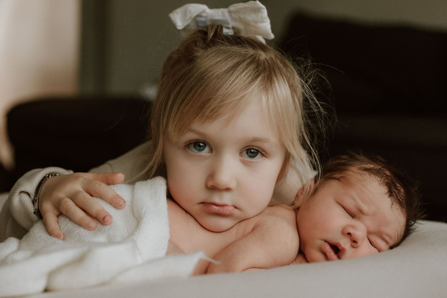 Sweet moment captured of sleeping baby with gentle embrace.