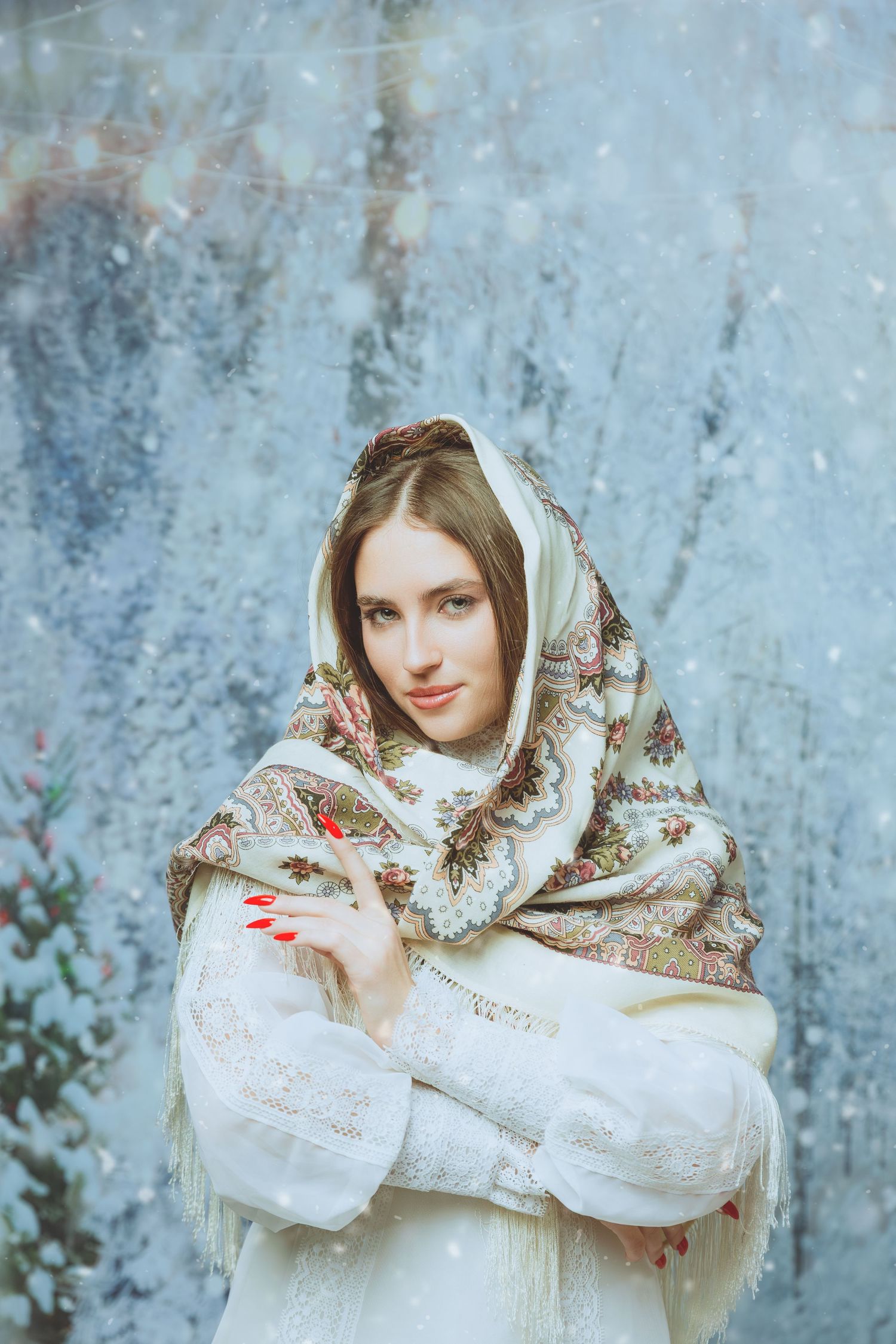Portrait in traditional white winter shawl against frosty blue background.