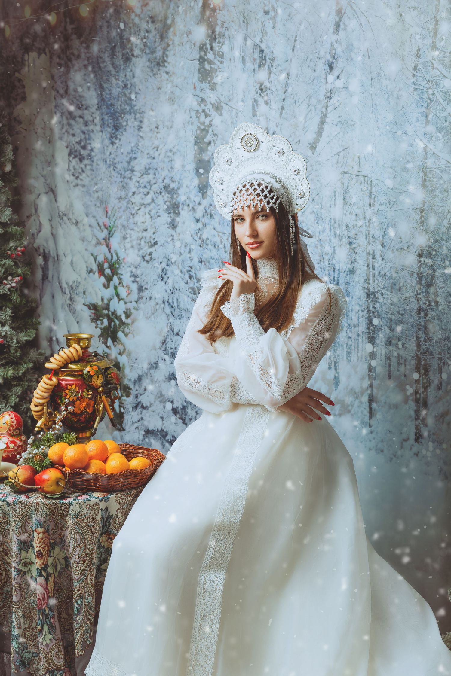 Person in white gown poses with winter decorations and seasonal fruits in frosty scene.