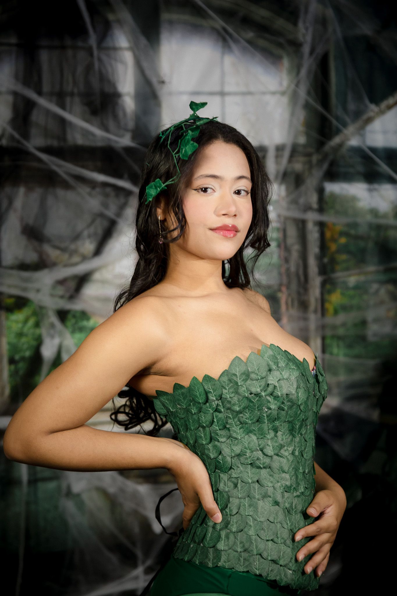 Fashion sequence showing a textured green strapless dress with dramatic lighting.