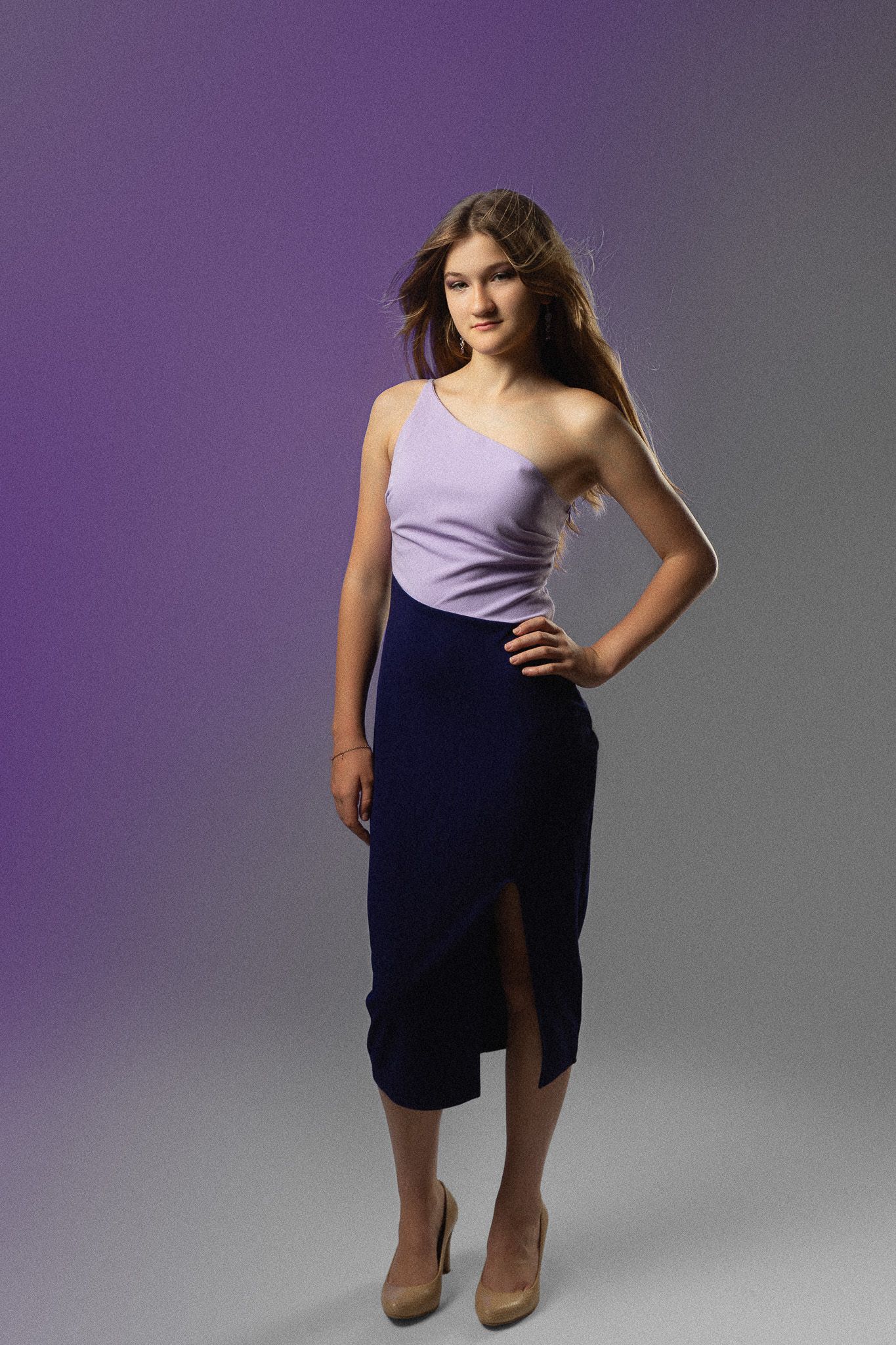 Fashion portrait series in purple and navy tones with dynamic poses.