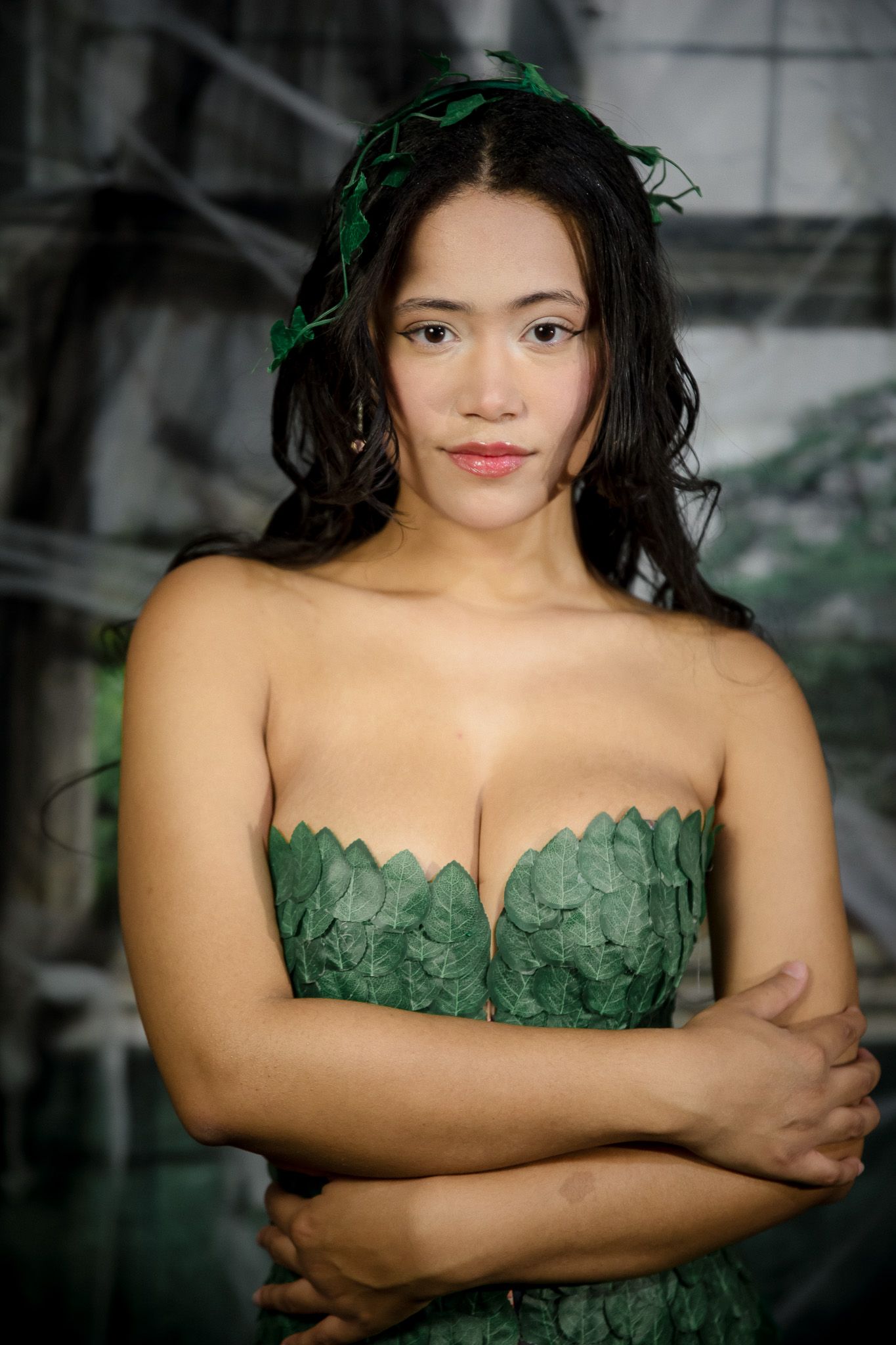 Glamour portraits featuring a strapless green leaf-patterned dress against a dark background.
