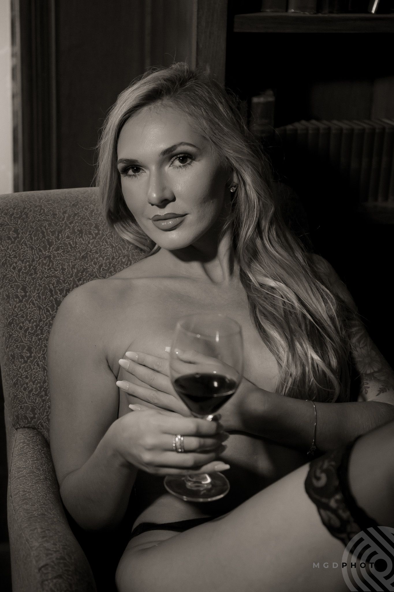 Monochrome portrait series featuring wine glass and intimate lighting.