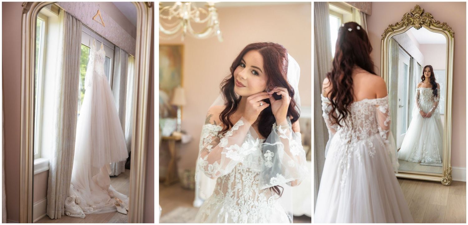 Bride in lace off-shoulder wedding gown adjusting earrings, reflected in ornate gold mirror in elegant bridal suite.