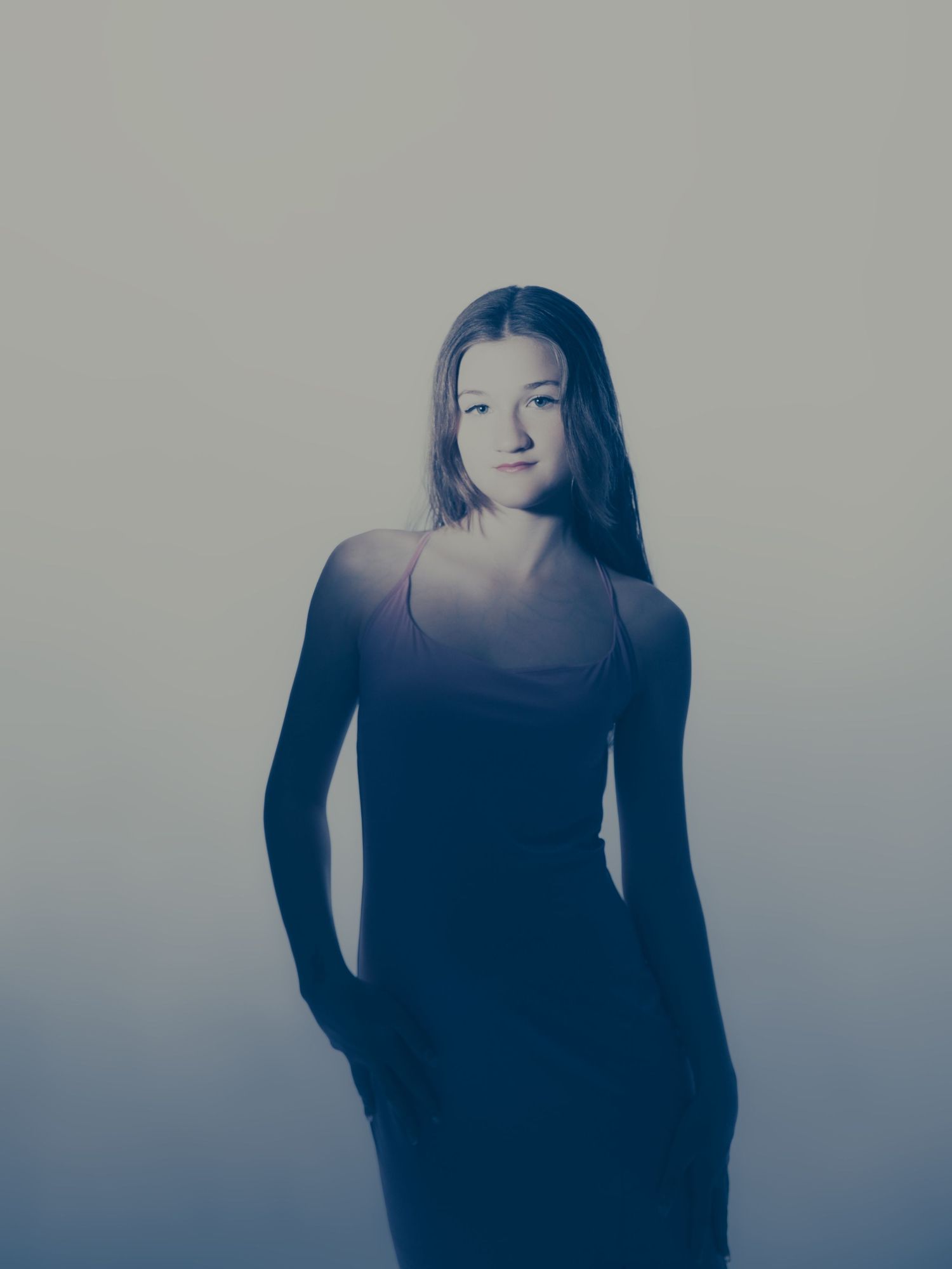 Moody portrait series with figure emerging from shadows in dark clothing.