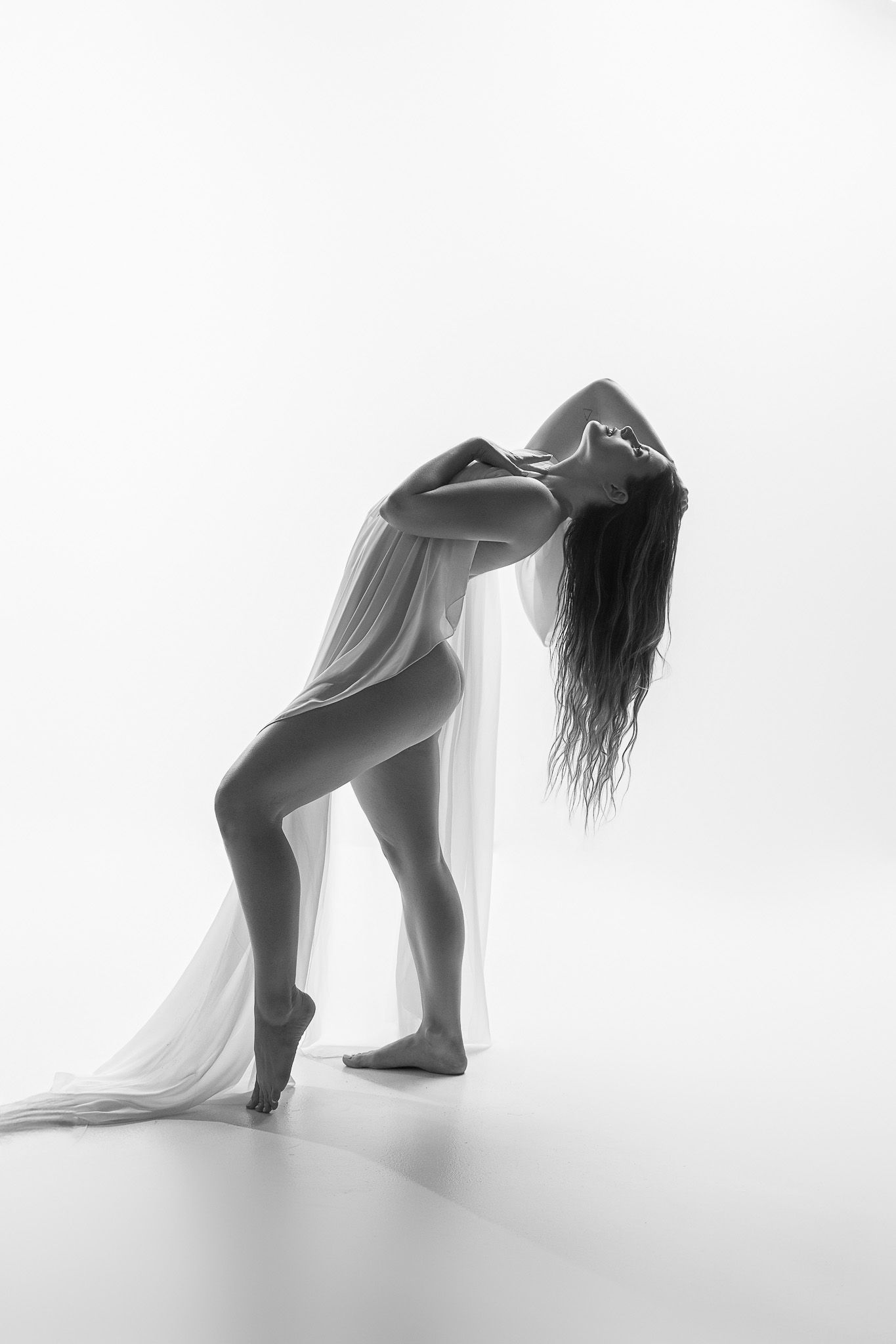 Artistic black and white photo series showing silhouettes of a dancer performing graceful backbend movements.