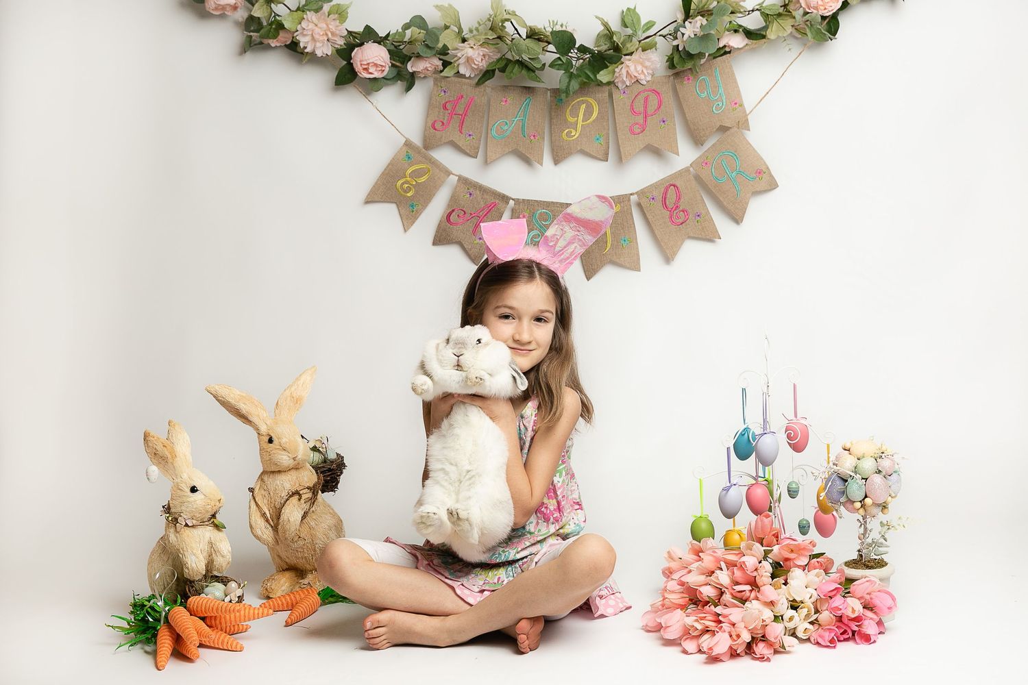 Easter themed portrait setup with spring flowers, bunnies and pastel decorations.