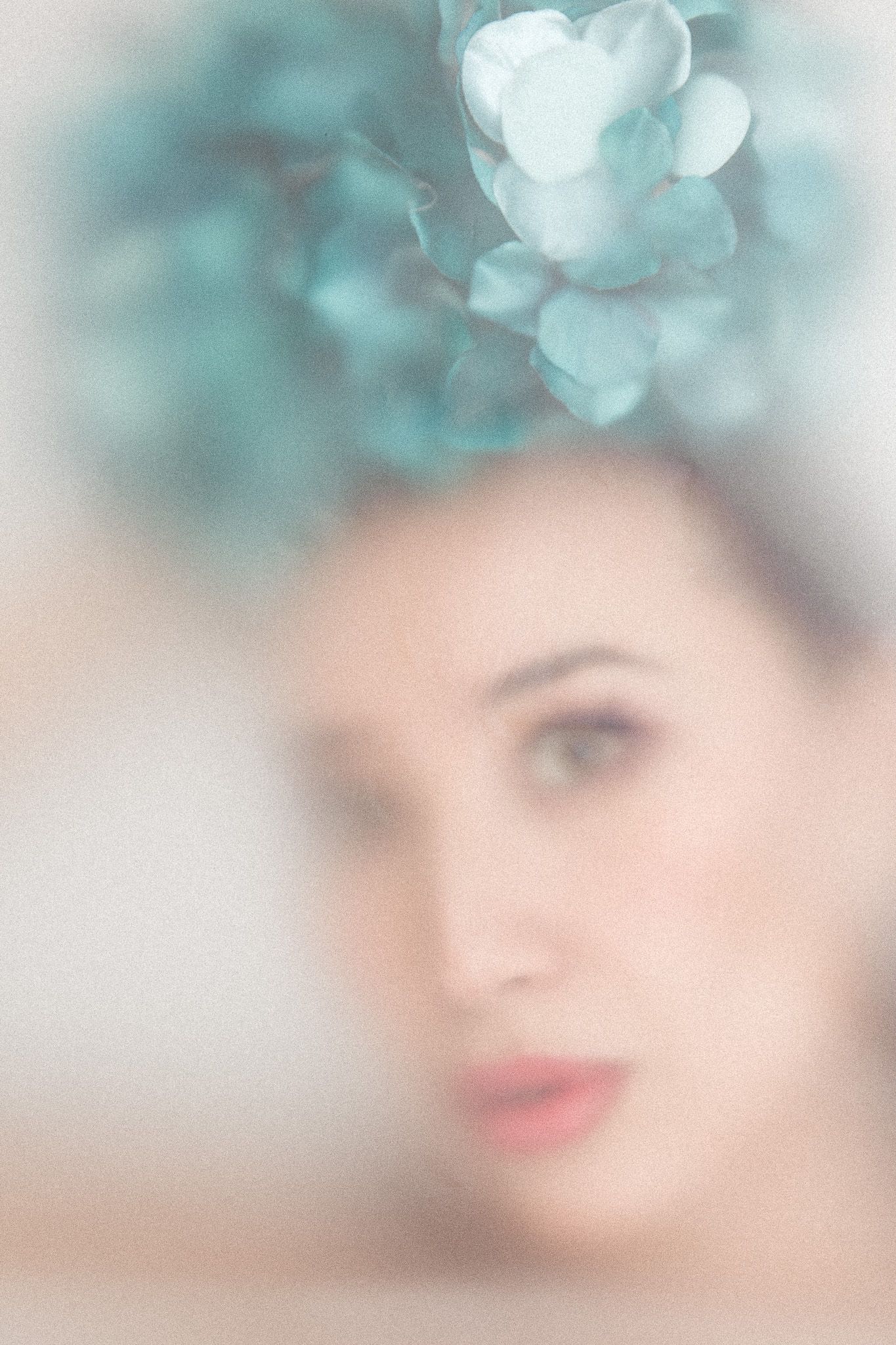 Dreamy portrait series with soft teal bokeh effects and ethereal lighting.