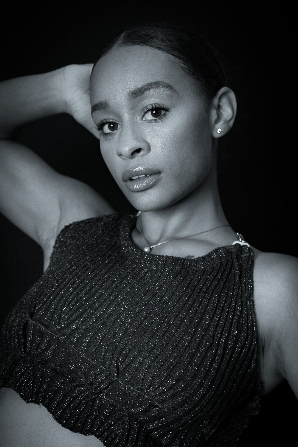 Black and white portrait series featuring subject in textured sweater with dramatic lighting.