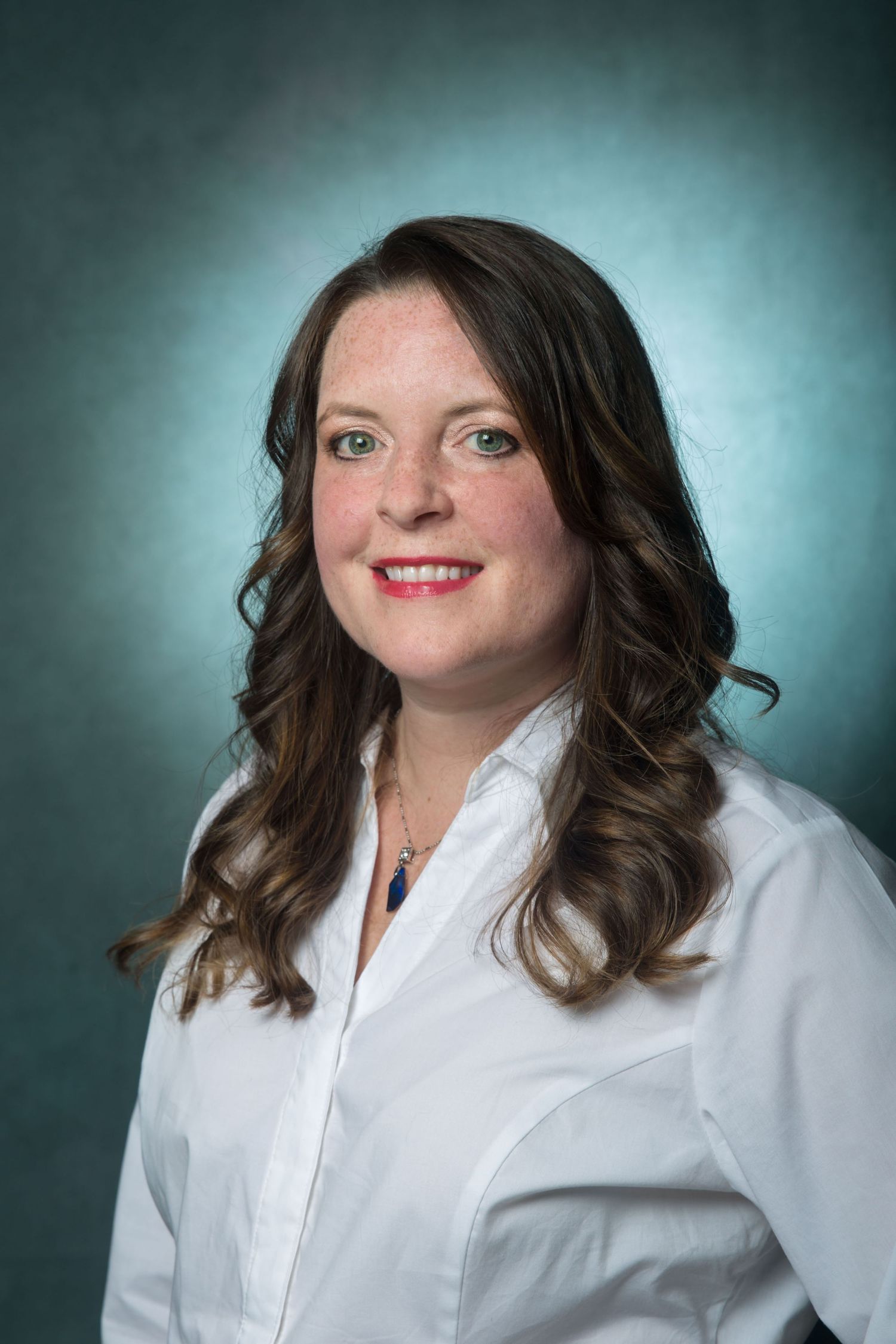 Professional headshot series against teal backdrop featuring white button-down shirt.
