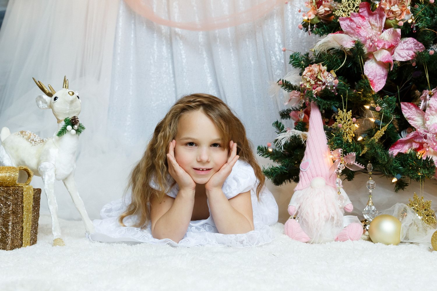 Romantic spring photo session with pink floral decorations and soft lighting.
