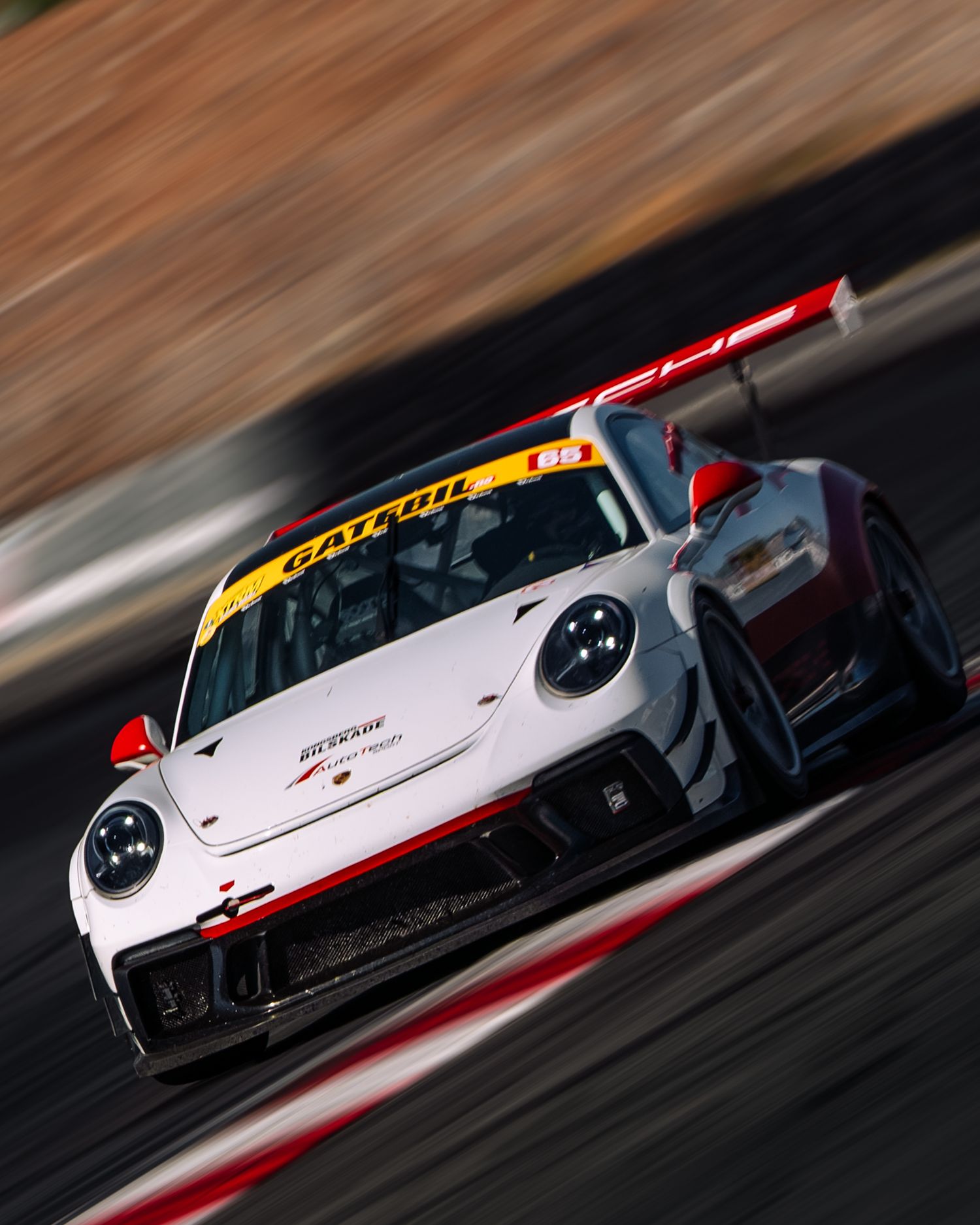 A series of white BMW racing cars with red accents navigate a race circuit with motion blur effects.