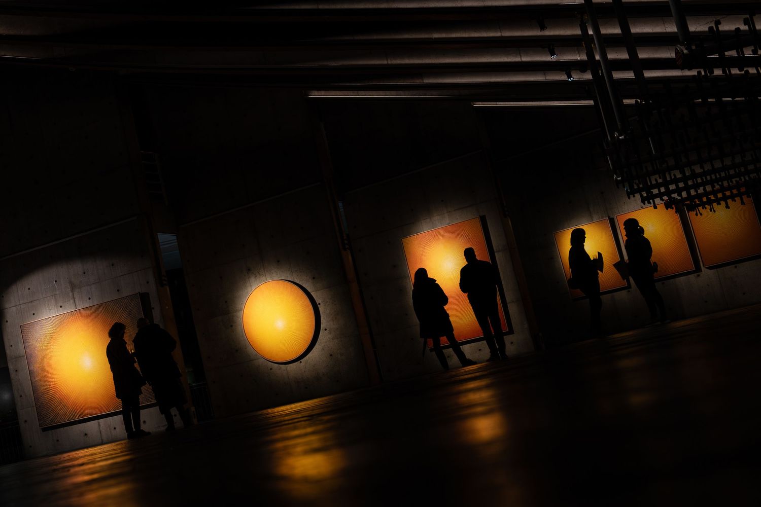 Dark corridor with warm glowing lights creating atmospheric shadows.