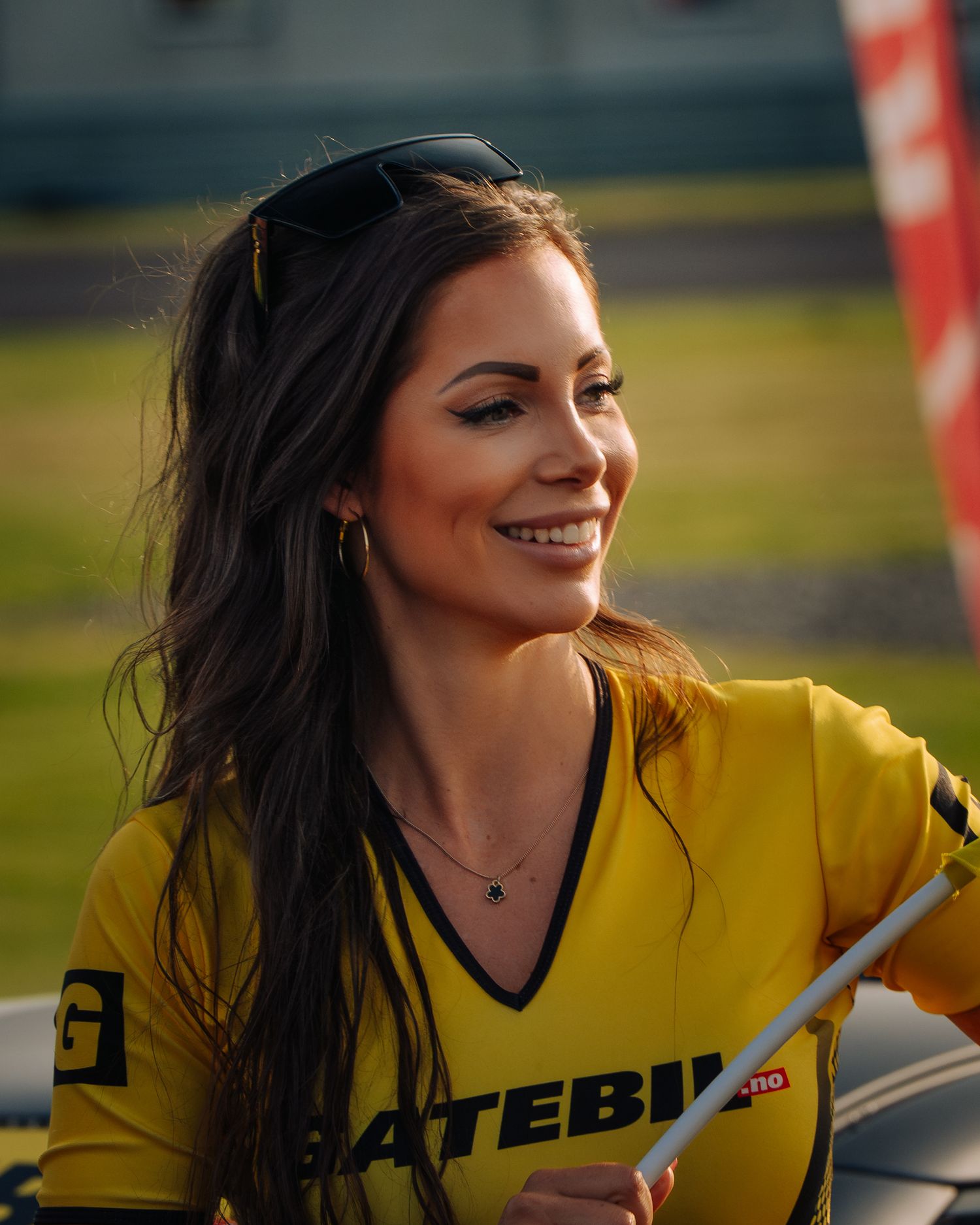 A woman in a yellow jersey smiles while posing in a sequence of outdoor photos.