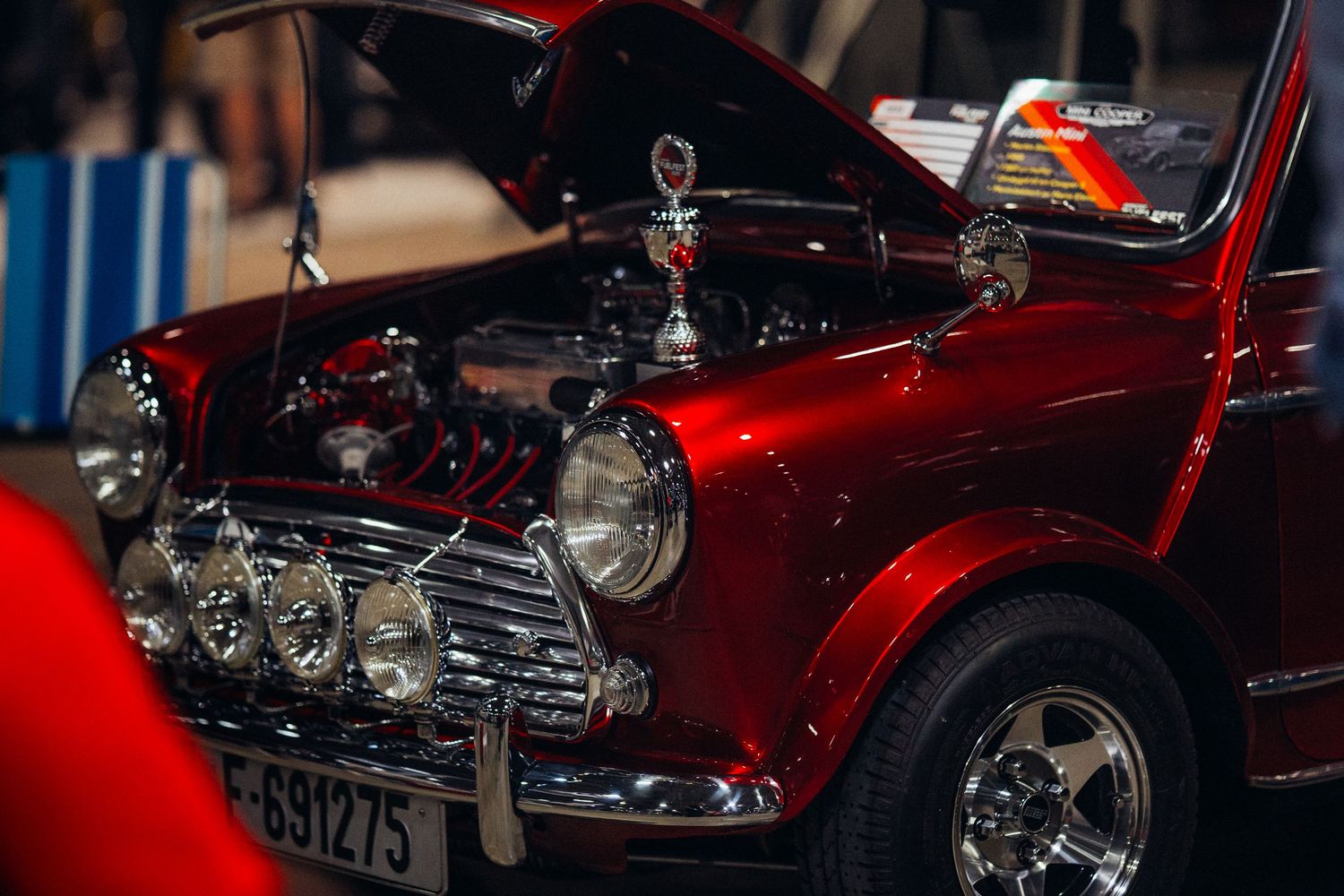 Red classic cars on display showcasing pristine vintage automotive design and chrome details.