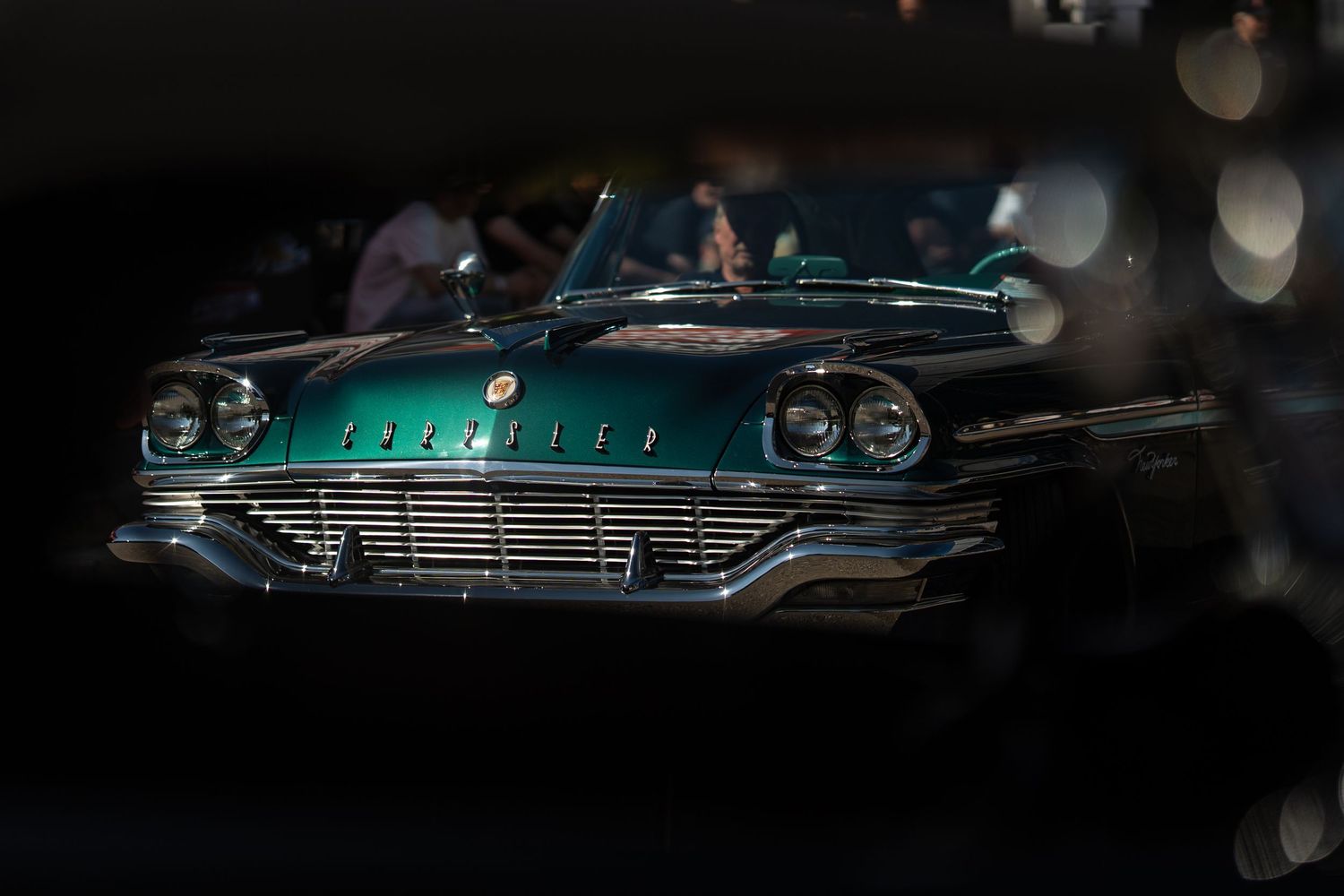 Classic Chrysler automobile photographed in moody lighting showing its retro styling.