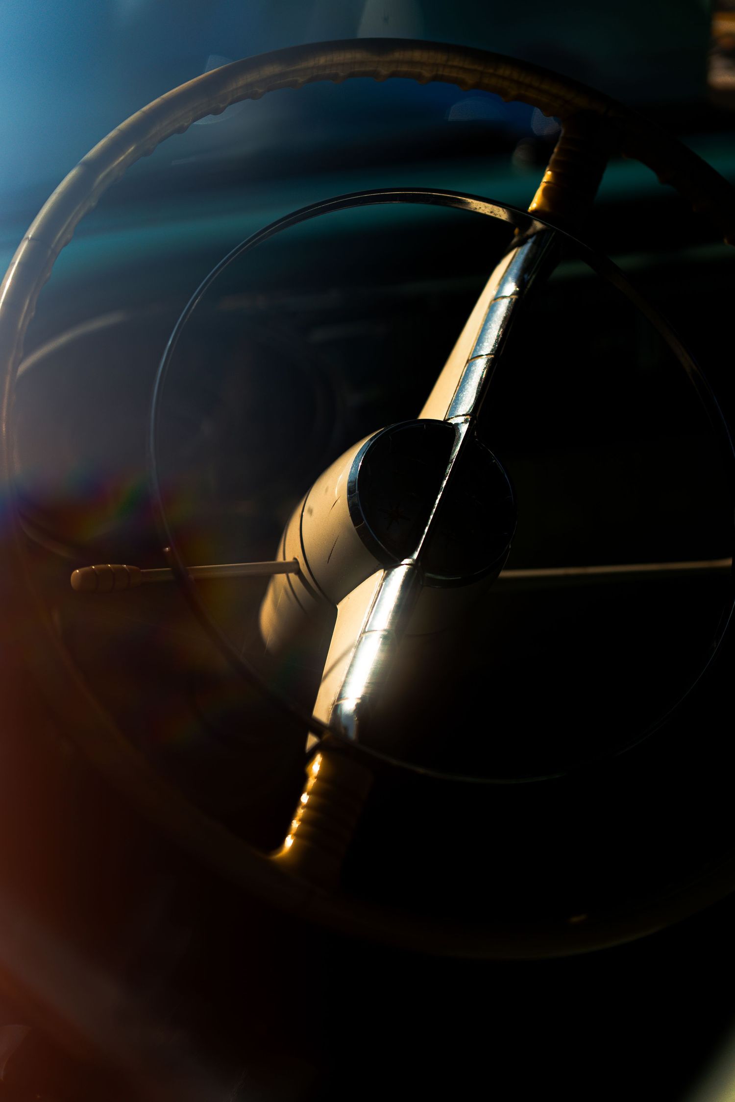 Artistic silhouette shot of a car's curves and edges against dramatic lighting.