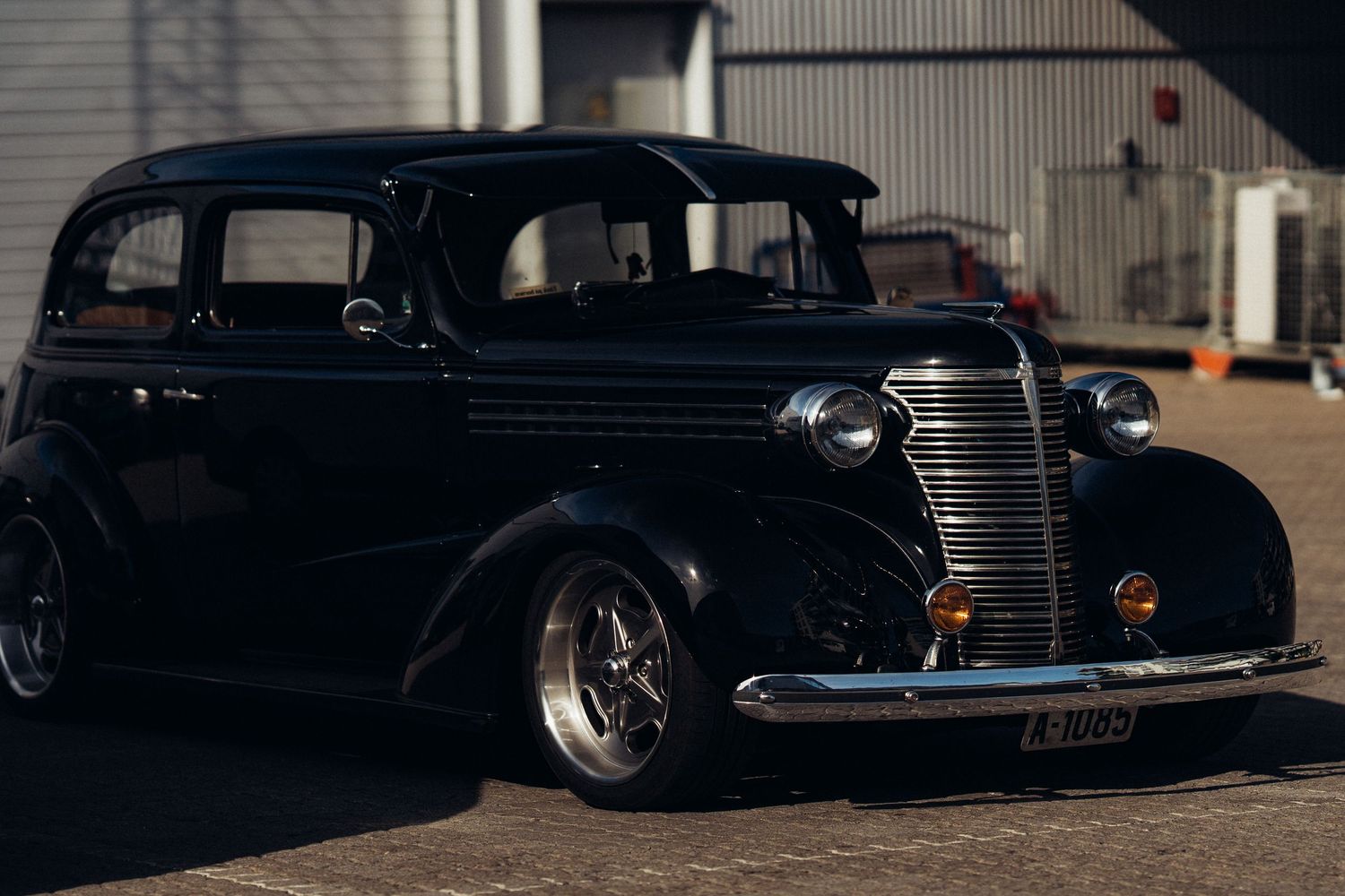 Collection of black vintage automobiles showcasing classic styling at a car show.