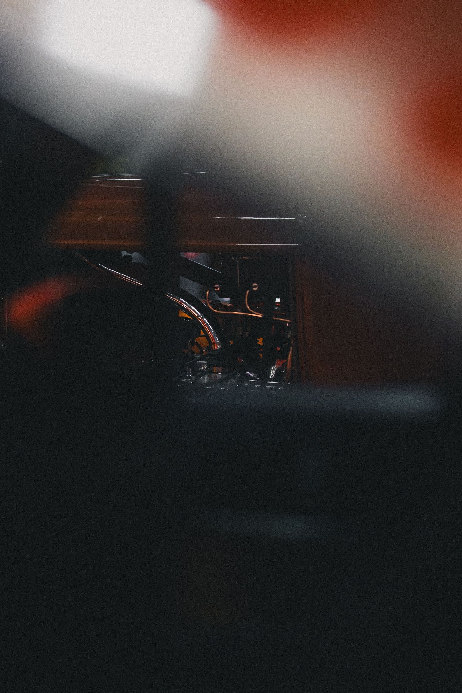 Artistic blurred photograph of automotive subjects with dramatic lighting and selective focus.