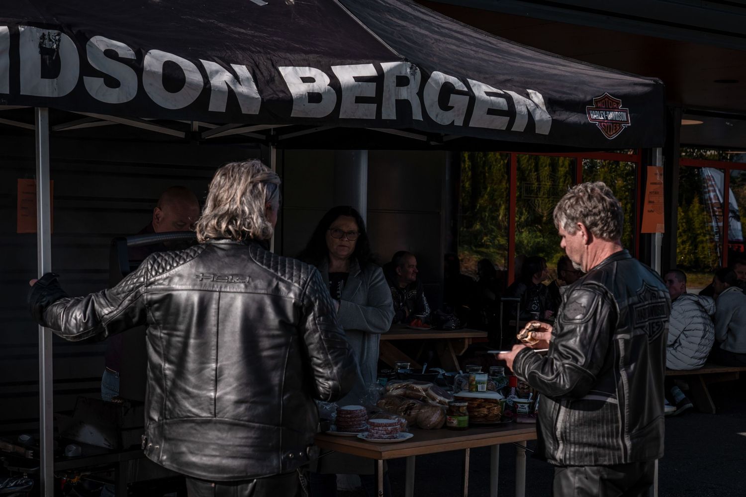 Leather-clad customers at an outdoor Davidson Bergen motorcycle event booth.