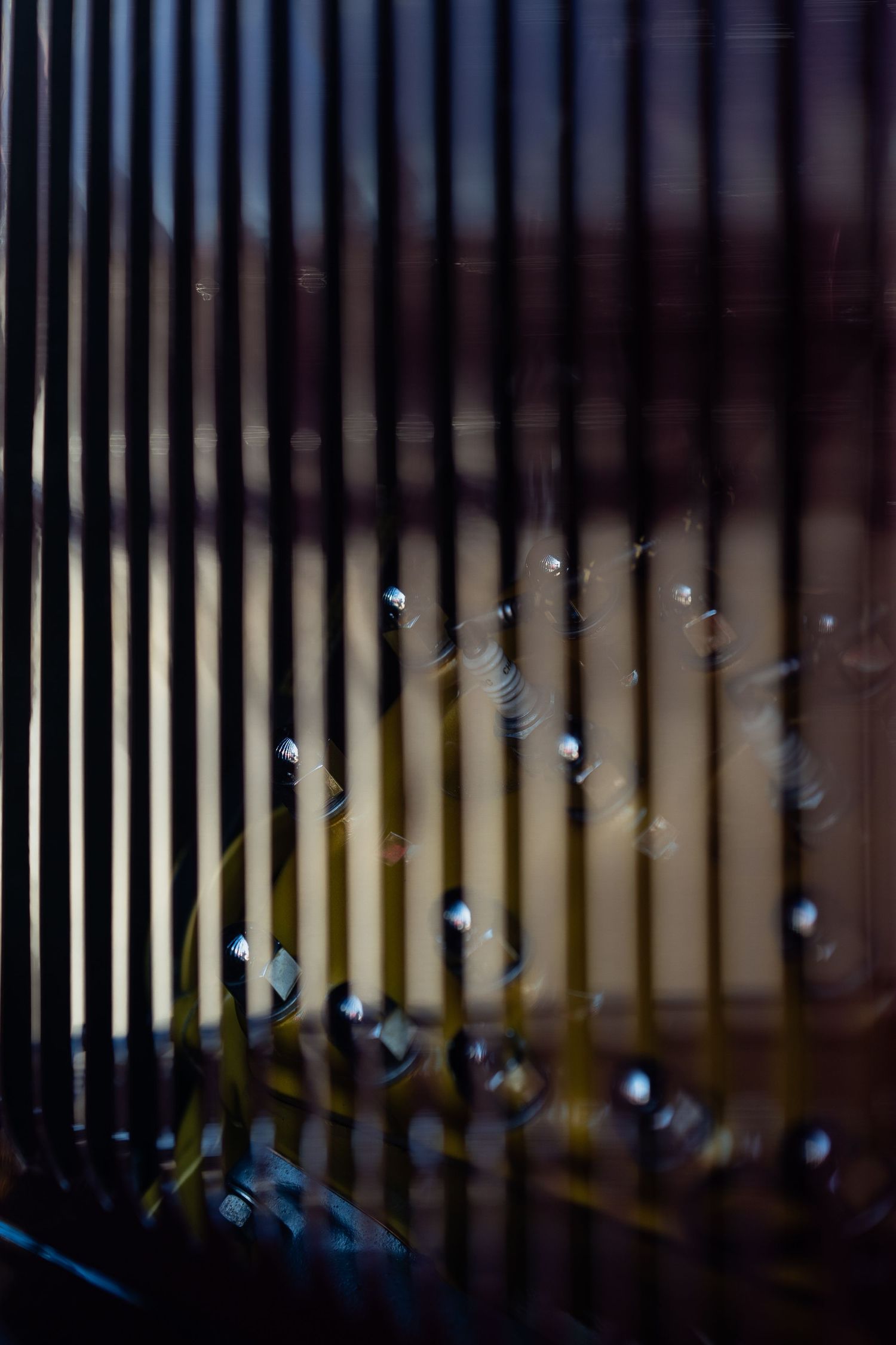 Abstract close-up of vertical metal lines creating a geometric pattern with bokeh effect.