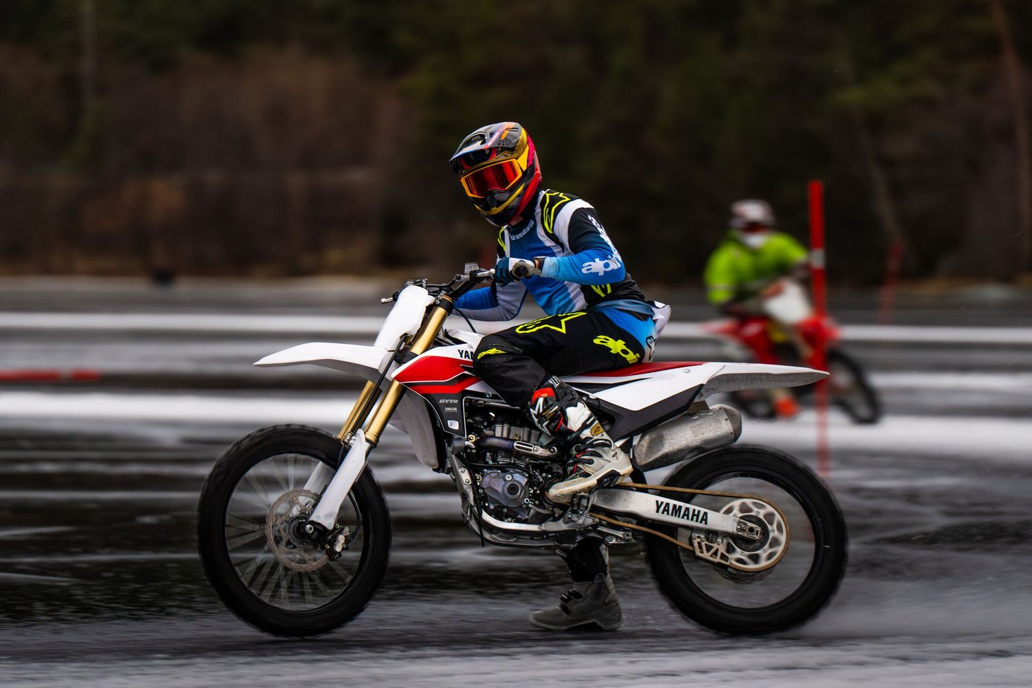 A sequence of motorcycle action shots showing a dirt bike performing jumps and maneuvers on a snowy track.