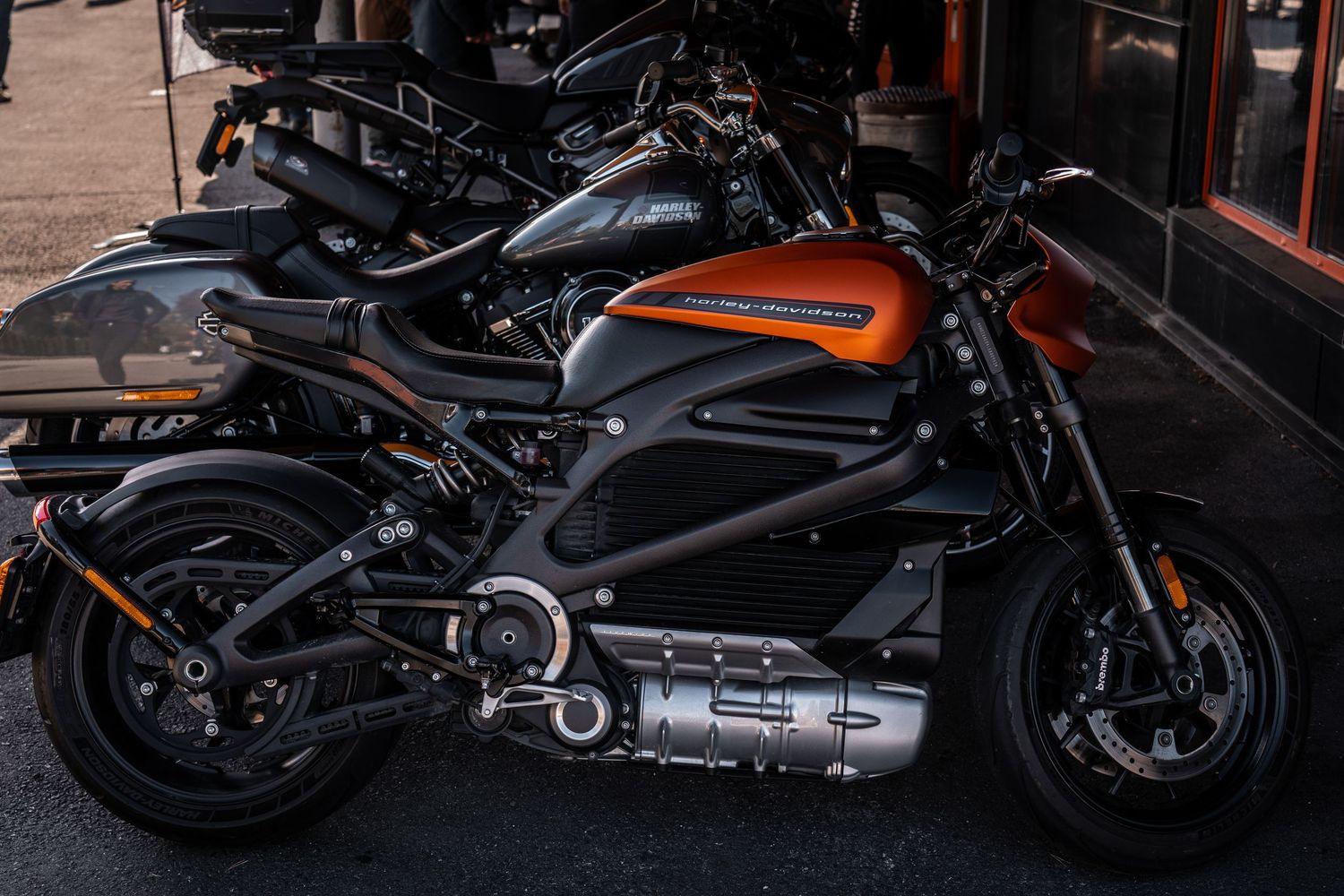 Sleek Harley-Davidson LiveWire electric motorcycle on display with orange accent details.