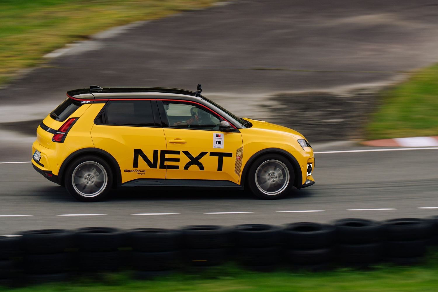 A bright yellow Volkswagen Golf R performance car speeds along a curvy road in motion-blurred action shots.