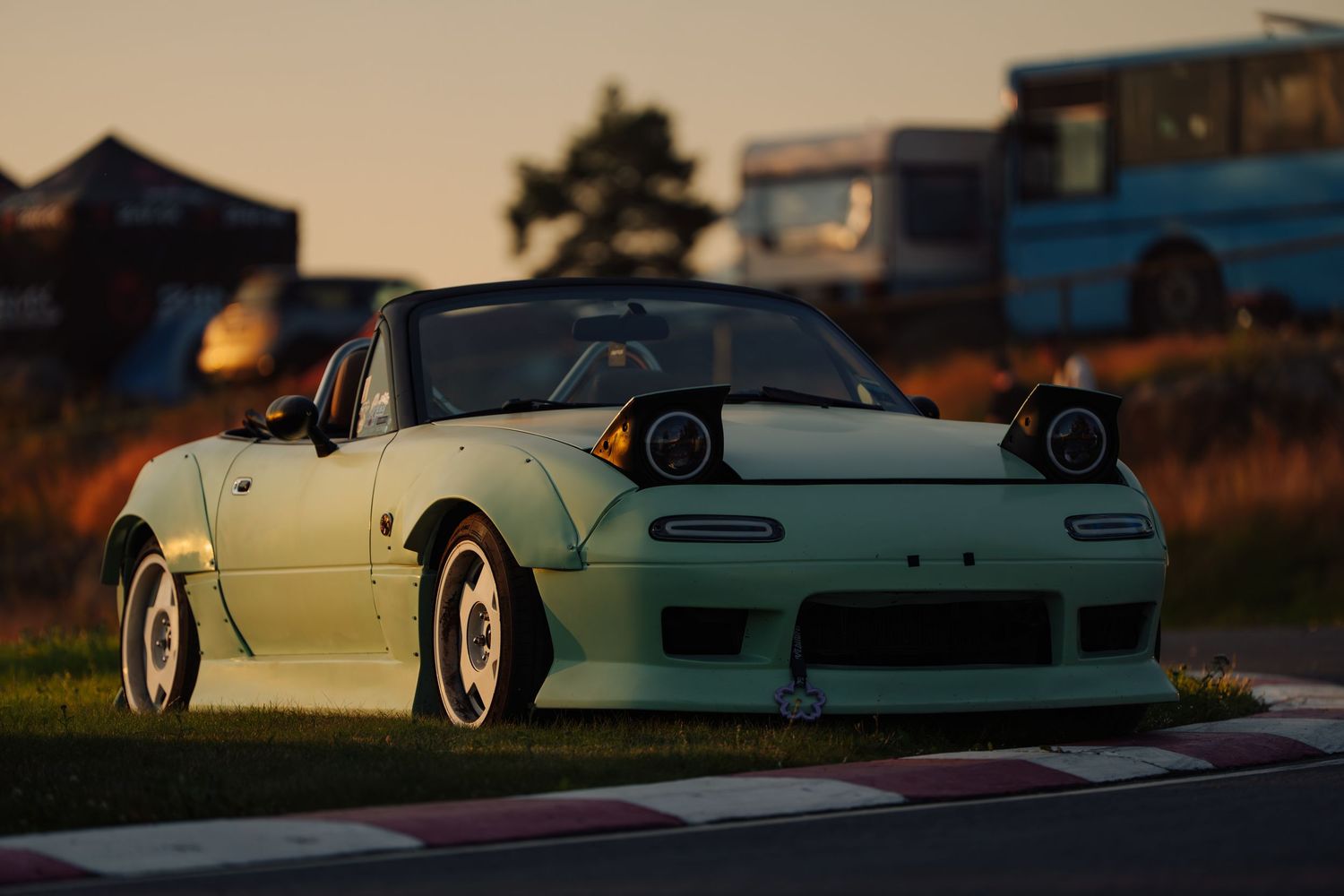 White Mazda Miata convertible sports car shown from multiple angles during sunset with dramatic lighting.