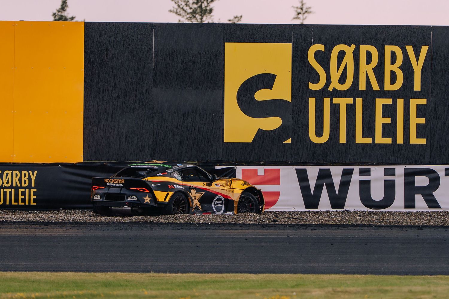 Yellow and black advertising signage displayed along a wall with text reading 'SORRY' and 'WUR' visible.