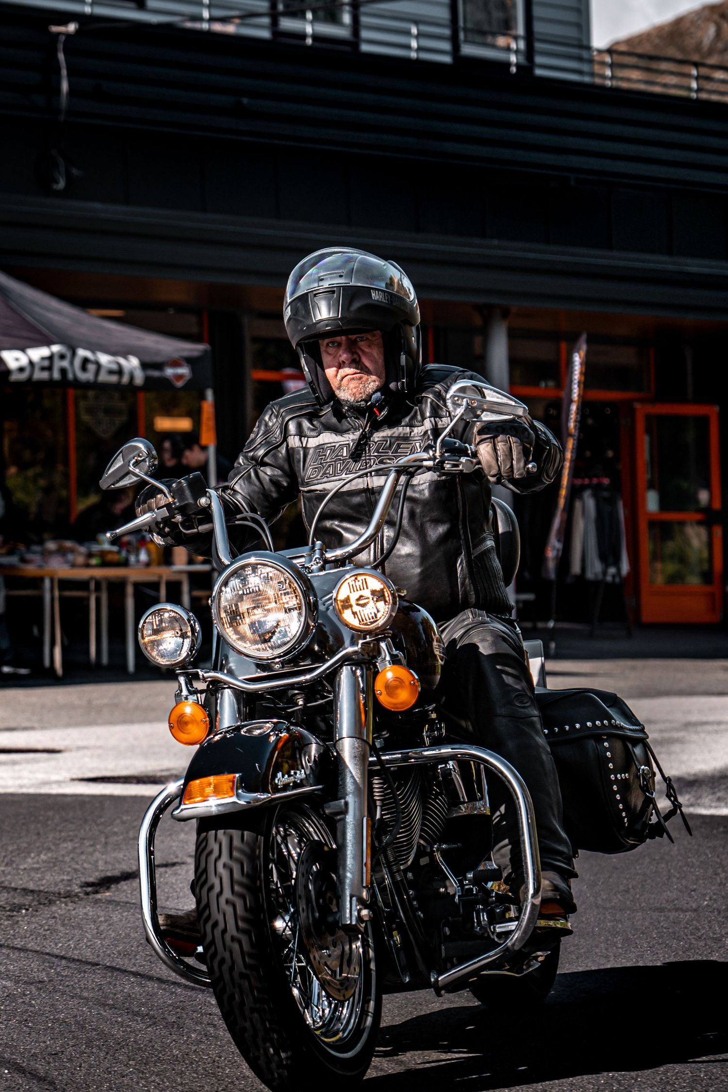 Close-up shot of a black Harley-Davidson motorcycle's front headlights and fairings in daylight.
