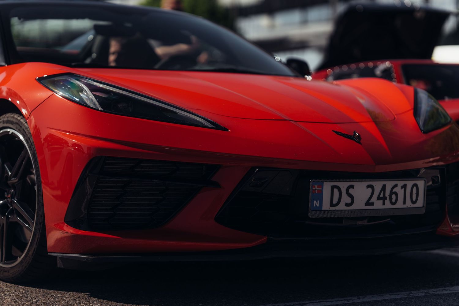 Front quarter view of a red Chevrolet Corvette C8 showing aggressive modern styling.