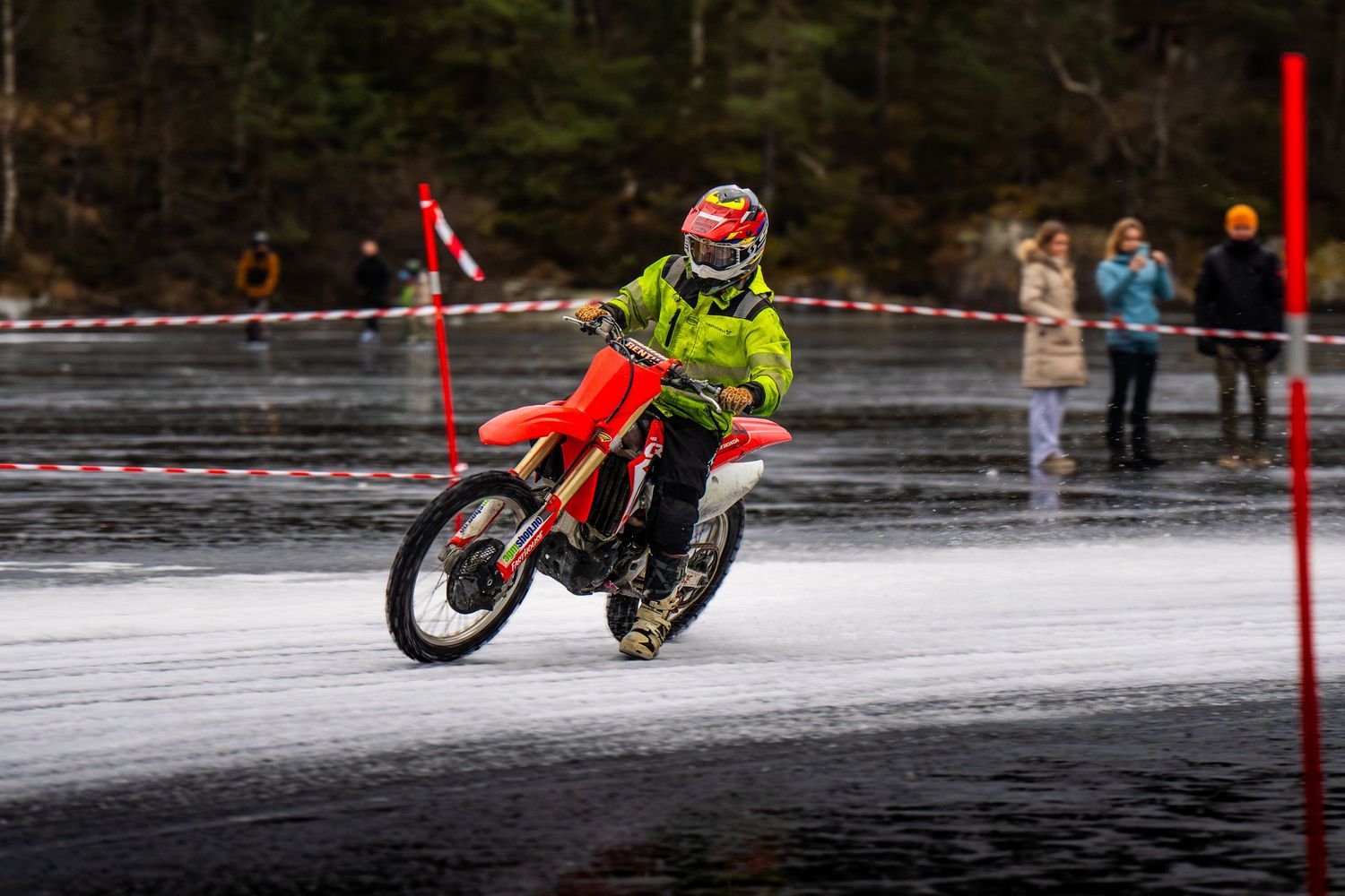 A sequence of motorcycle stunts showing a bike performing aerial tricks and maneuvers on a snowy surface.